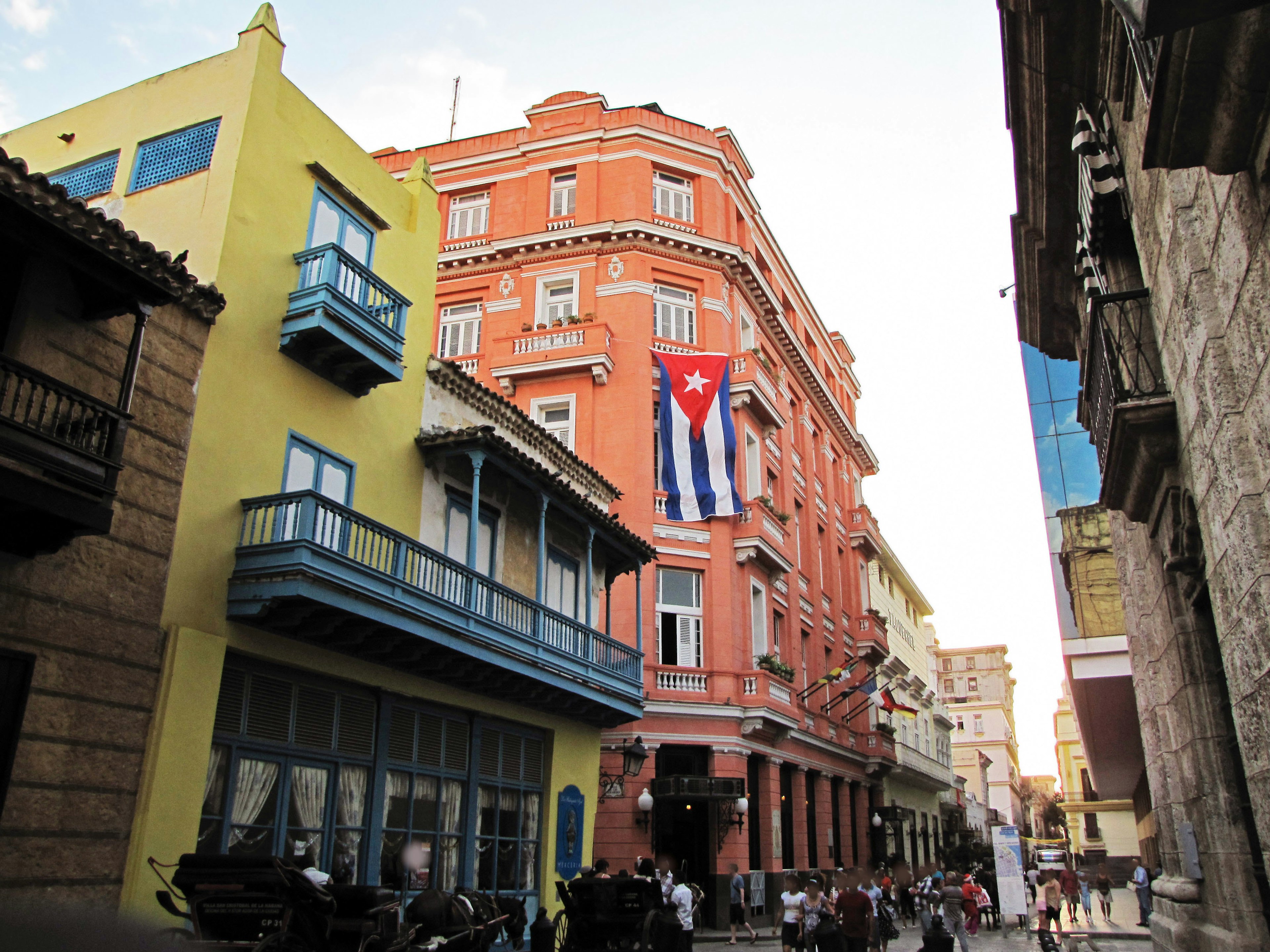 Colorful buildings with a Cuban flag visible in the streets of Havana