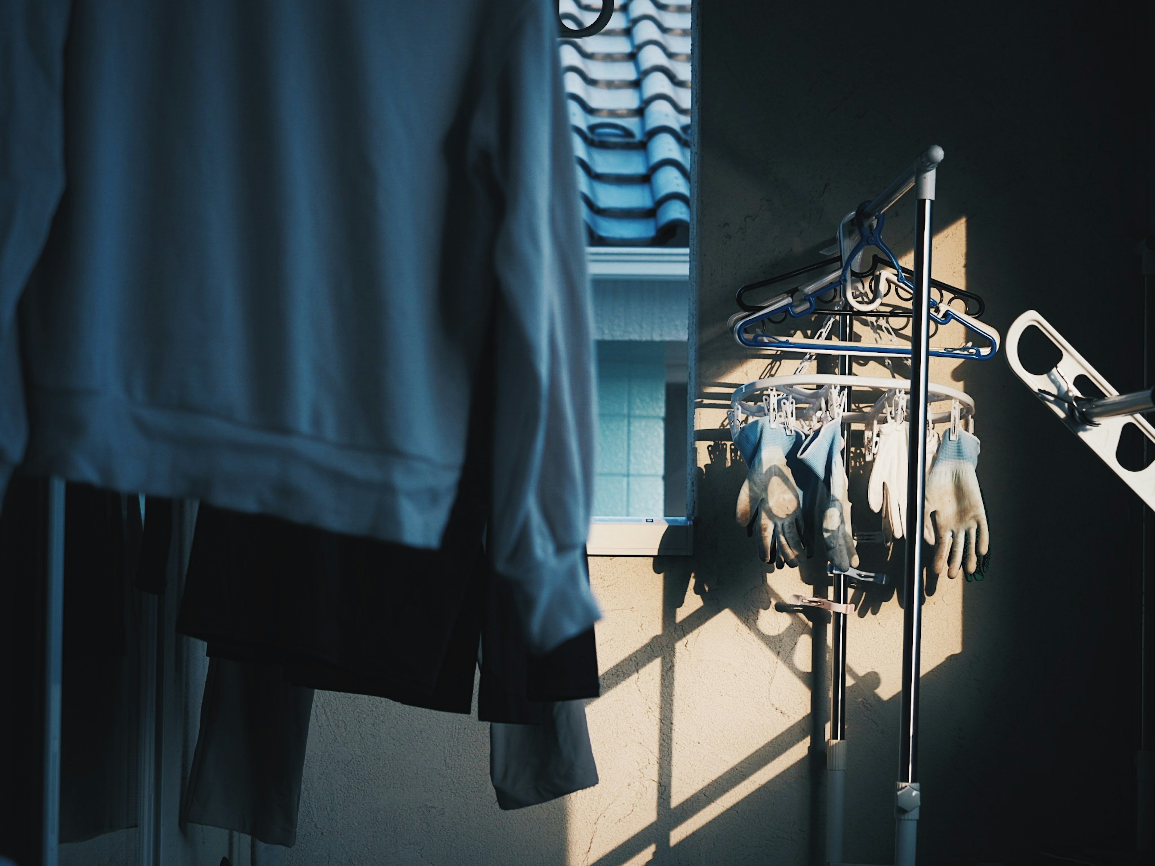 Clothes and gloves hanging to dry in soft light