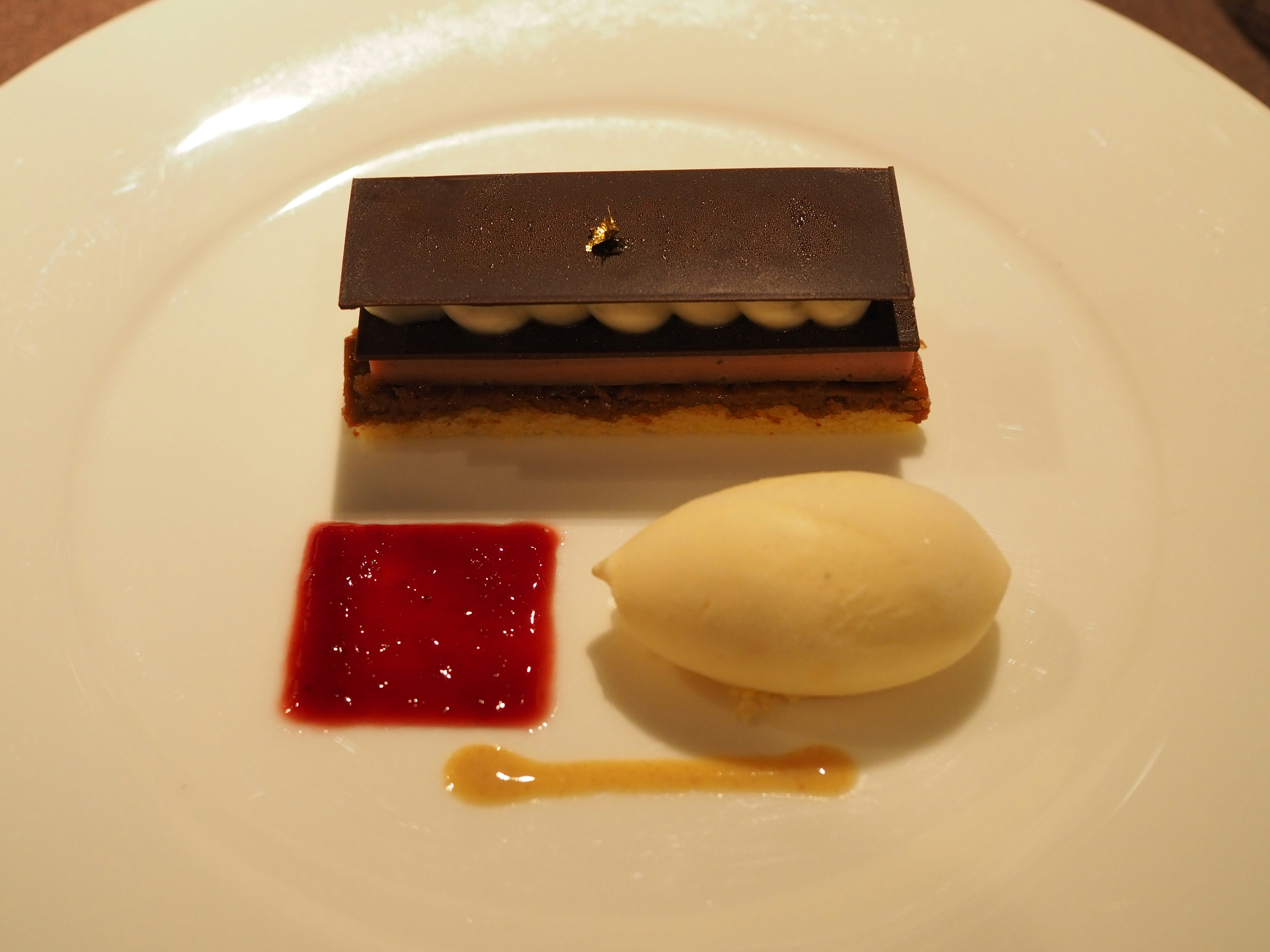 A beautifully plated dessert featuring a chocolate cake and ice cream