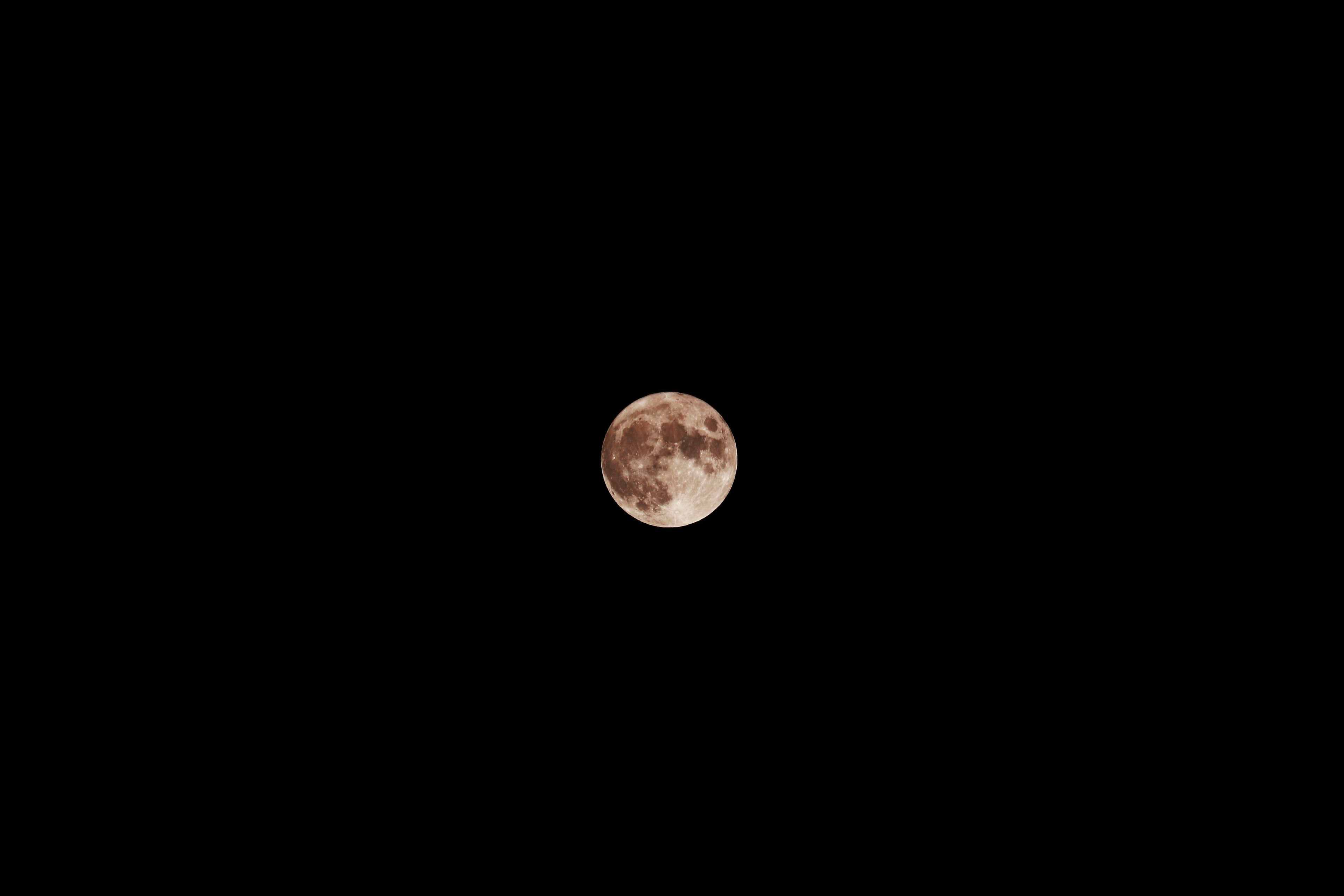 Detailed close-up of a full moon shining in the night sky