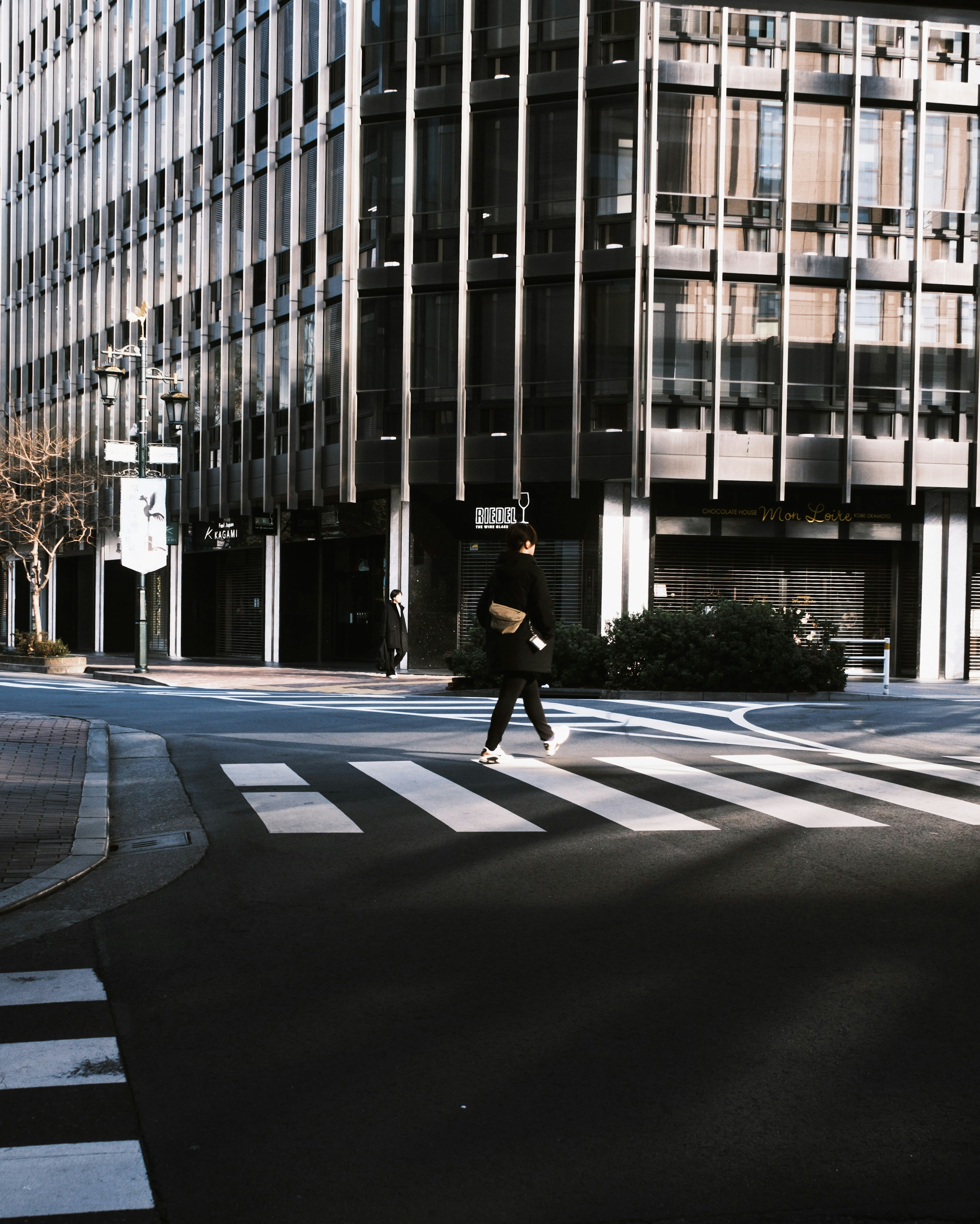 A person crossing the street at a city intersection