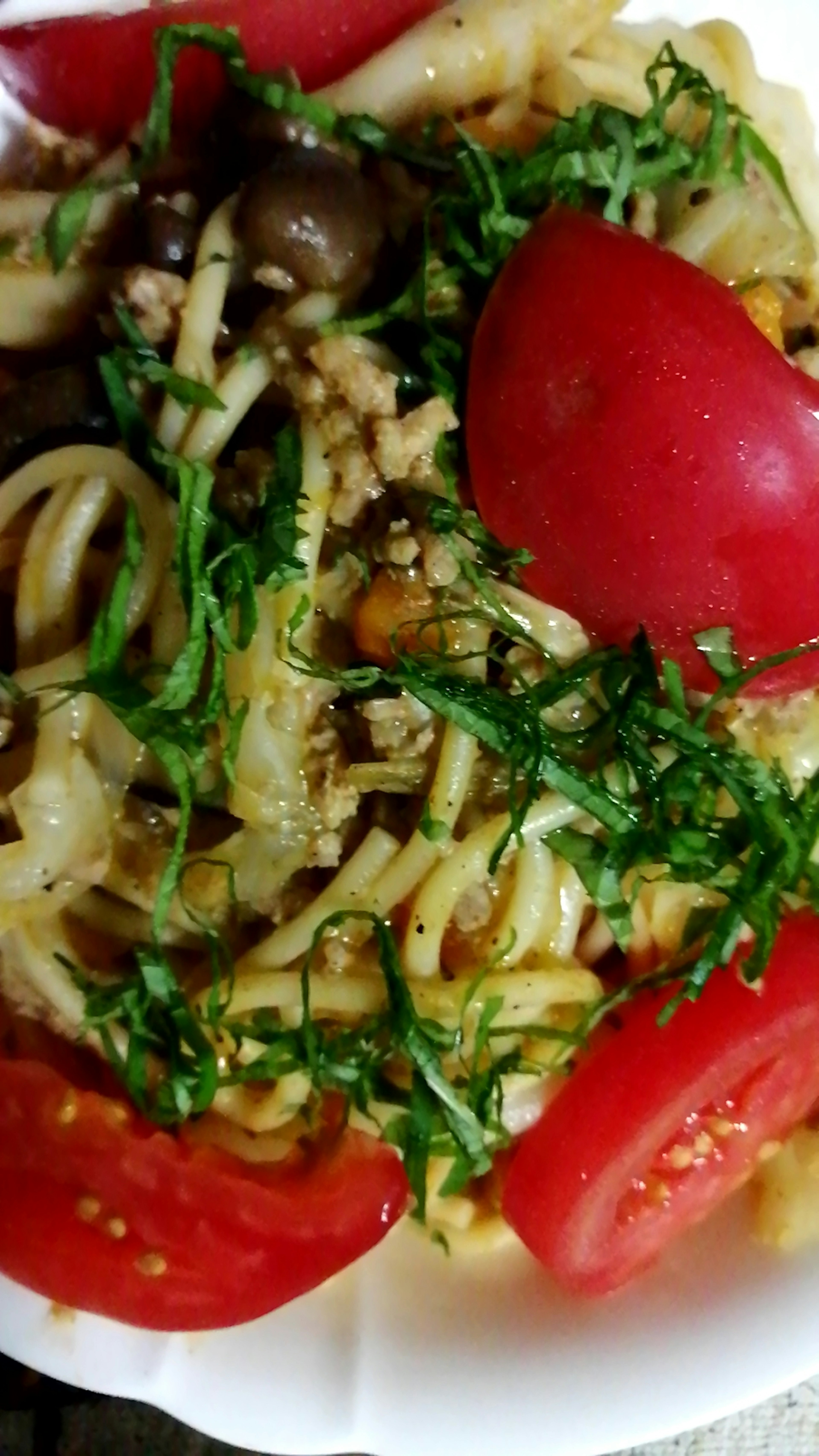 Pasta dish topped with tomatoes and herbs