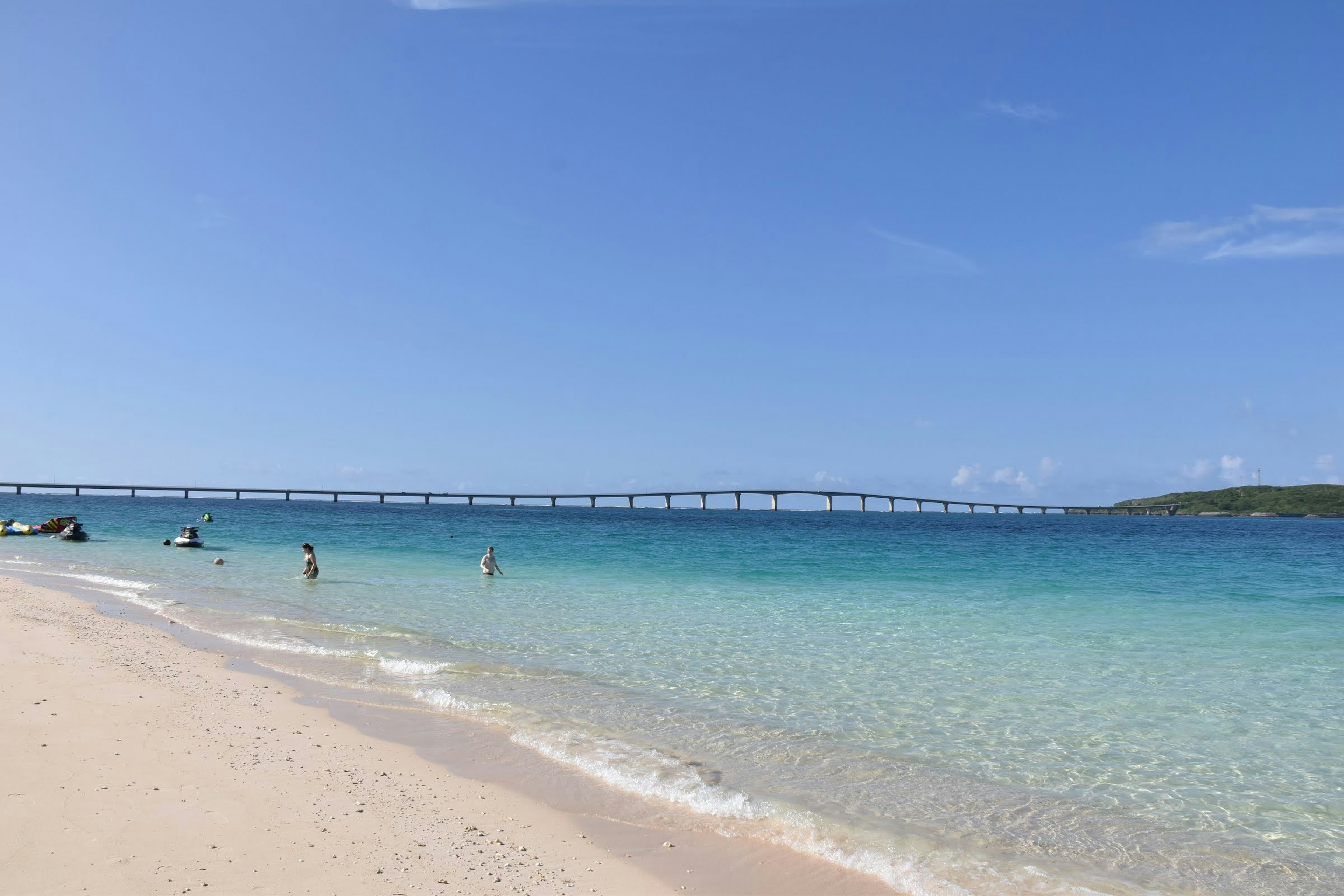 A beautiful beach with people enjoying the clear blue water