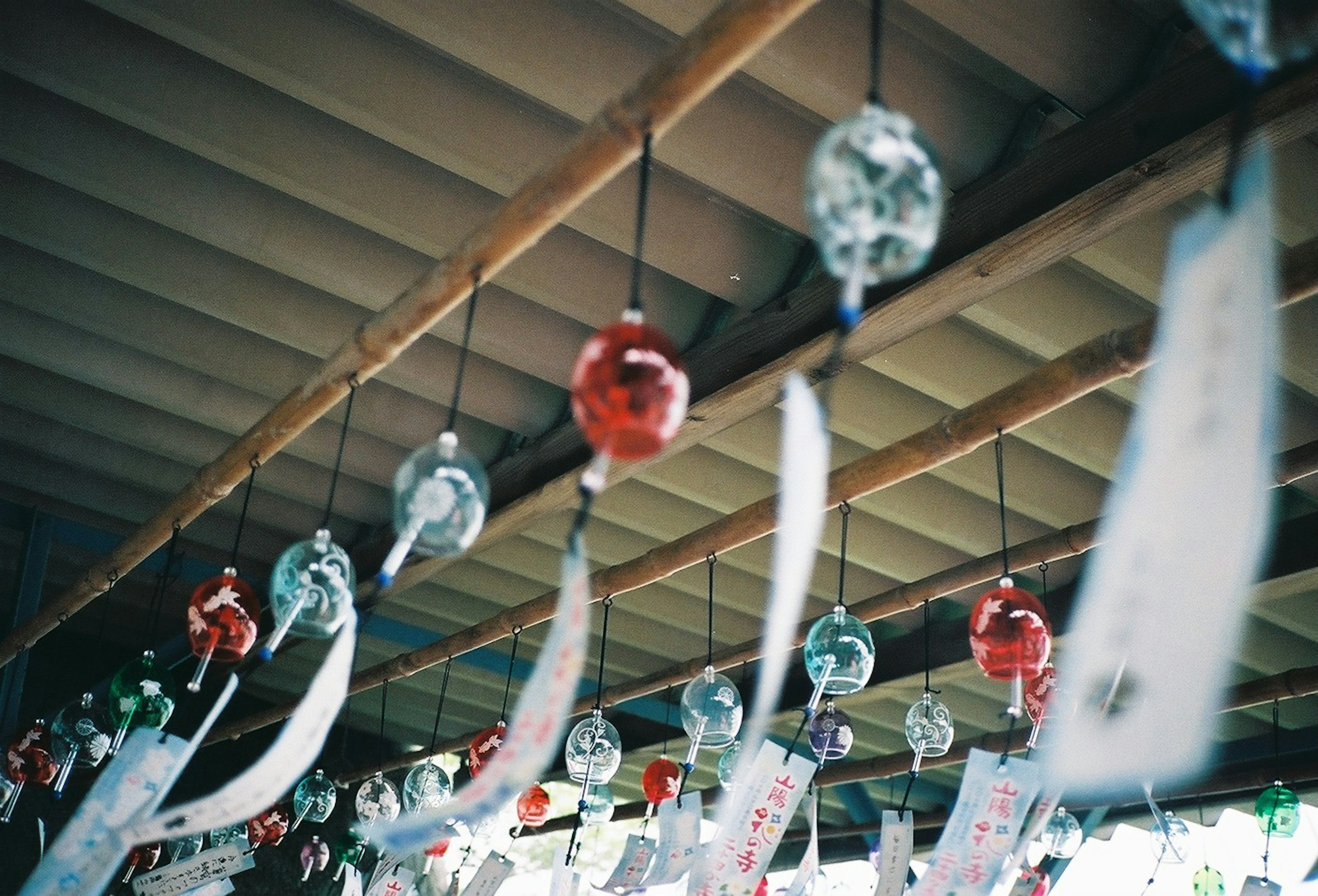 Colorful wind chimes hanging in an indoor setting