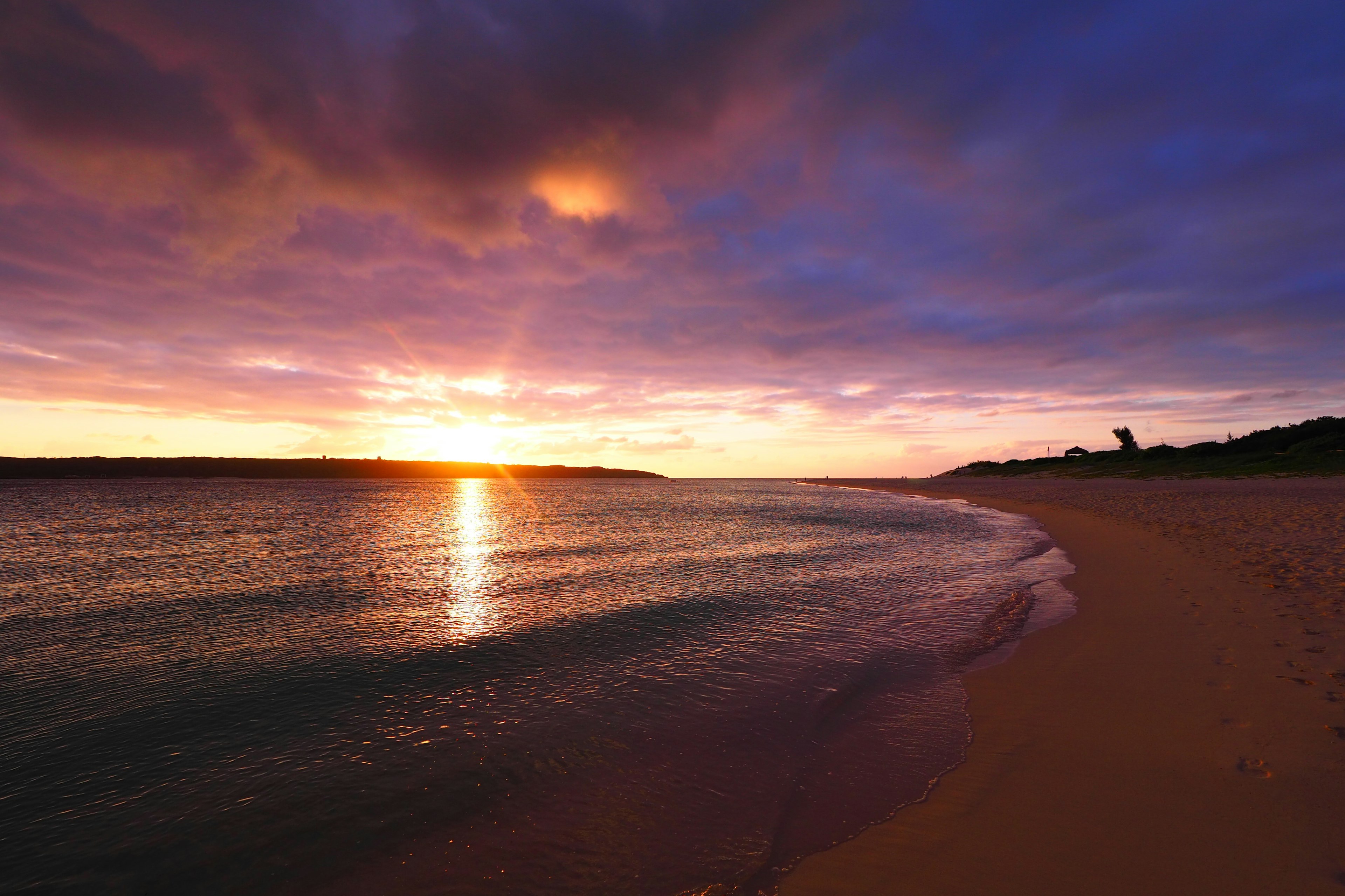 Beautiful sunset over the ocean with vibrant purple and orange sky