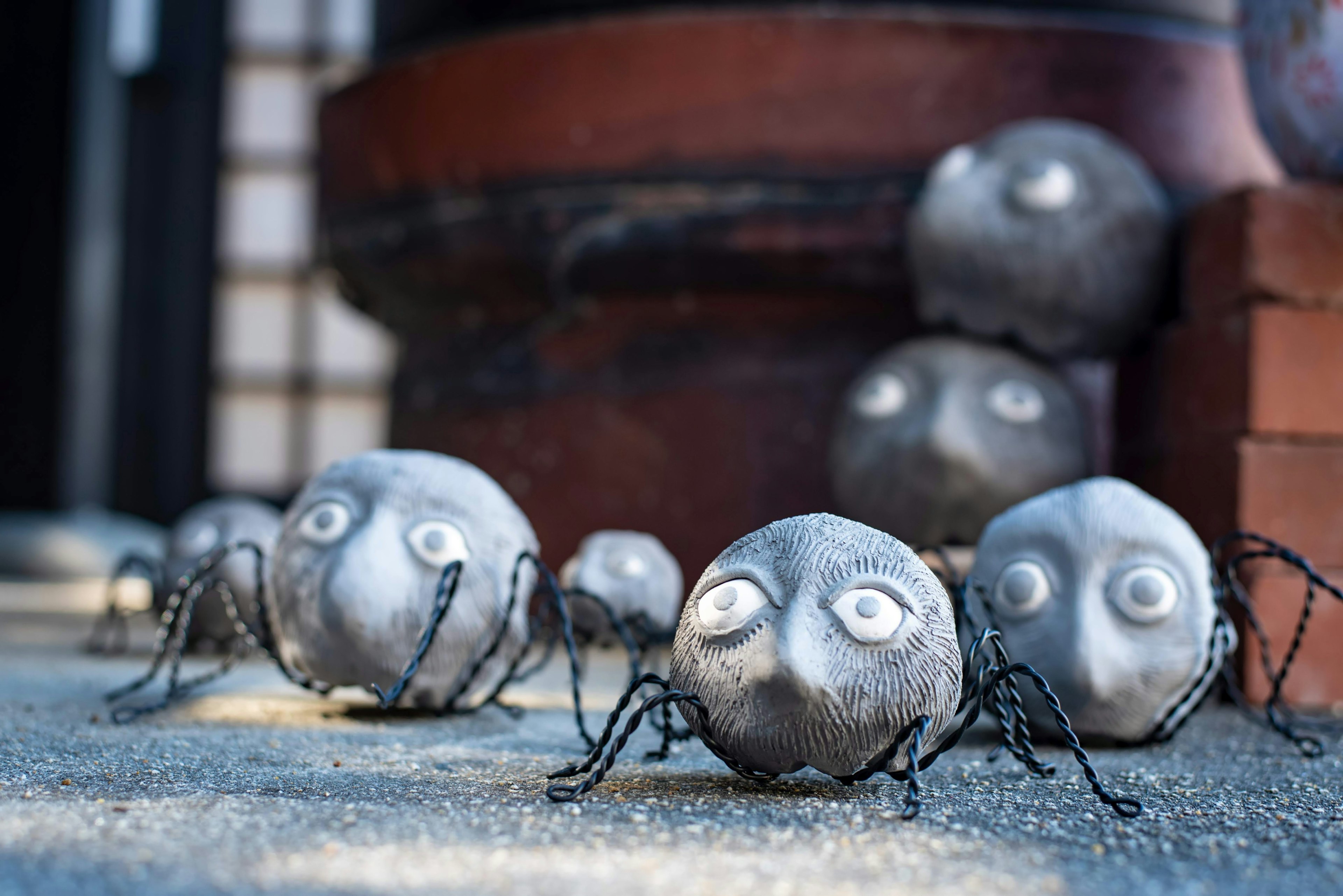 Small stone-like creatures with unique faces arranged on the ground