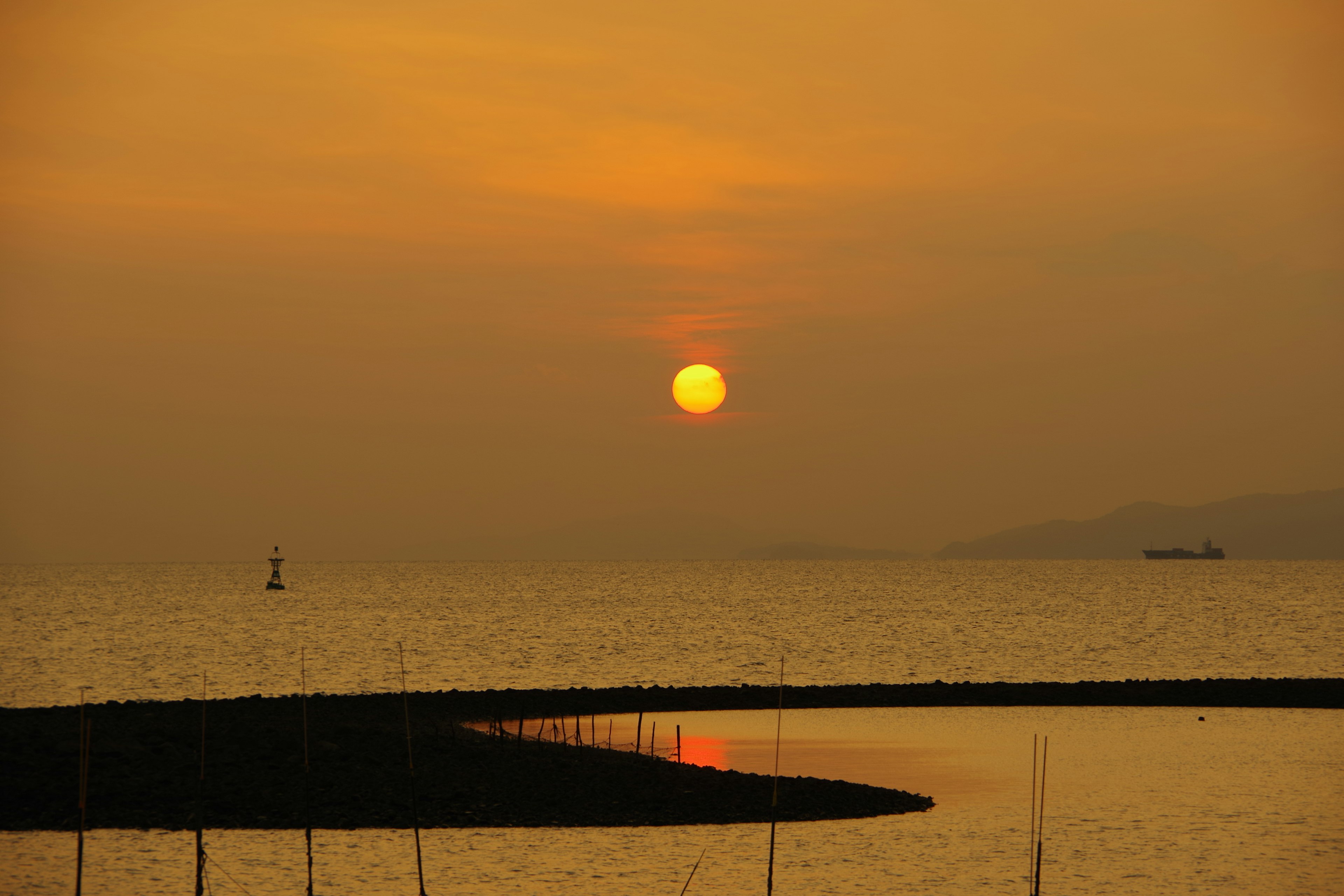 Beautiful landscape with sunset reflecting on the sea