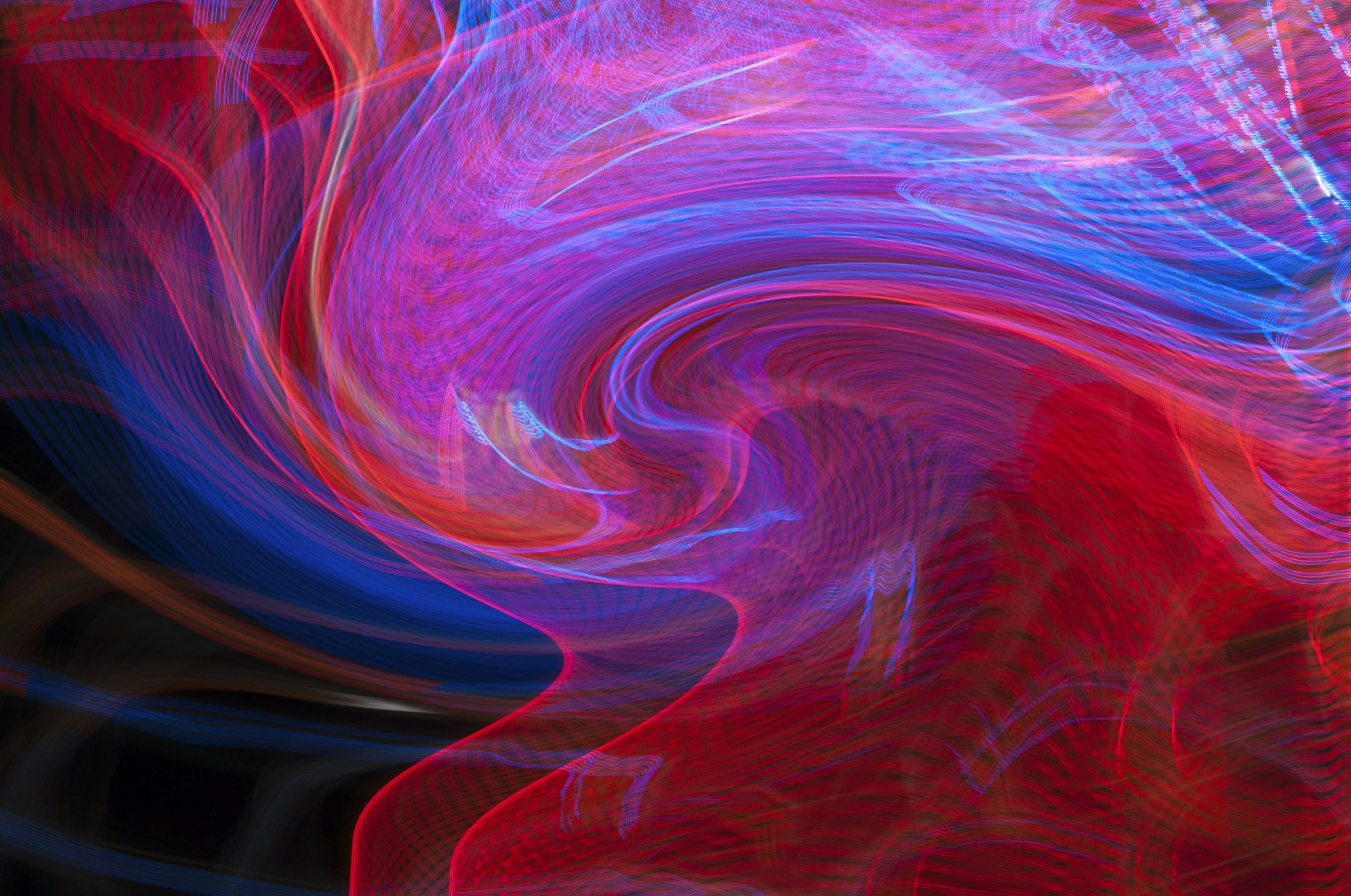 Abstract image featuring vibrant swirls of blue and red