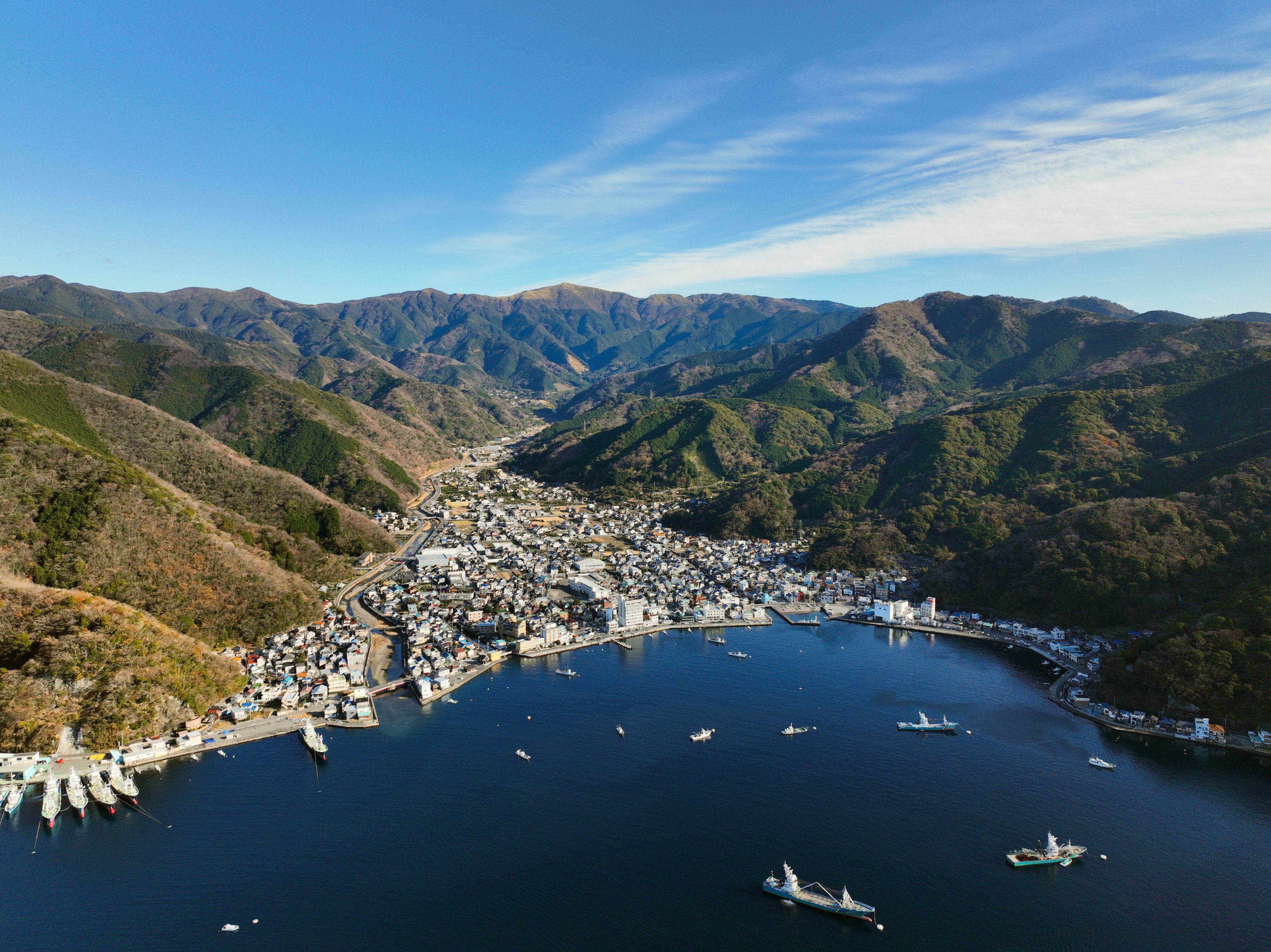 Aerial view of a coastal town surrounded by mountains