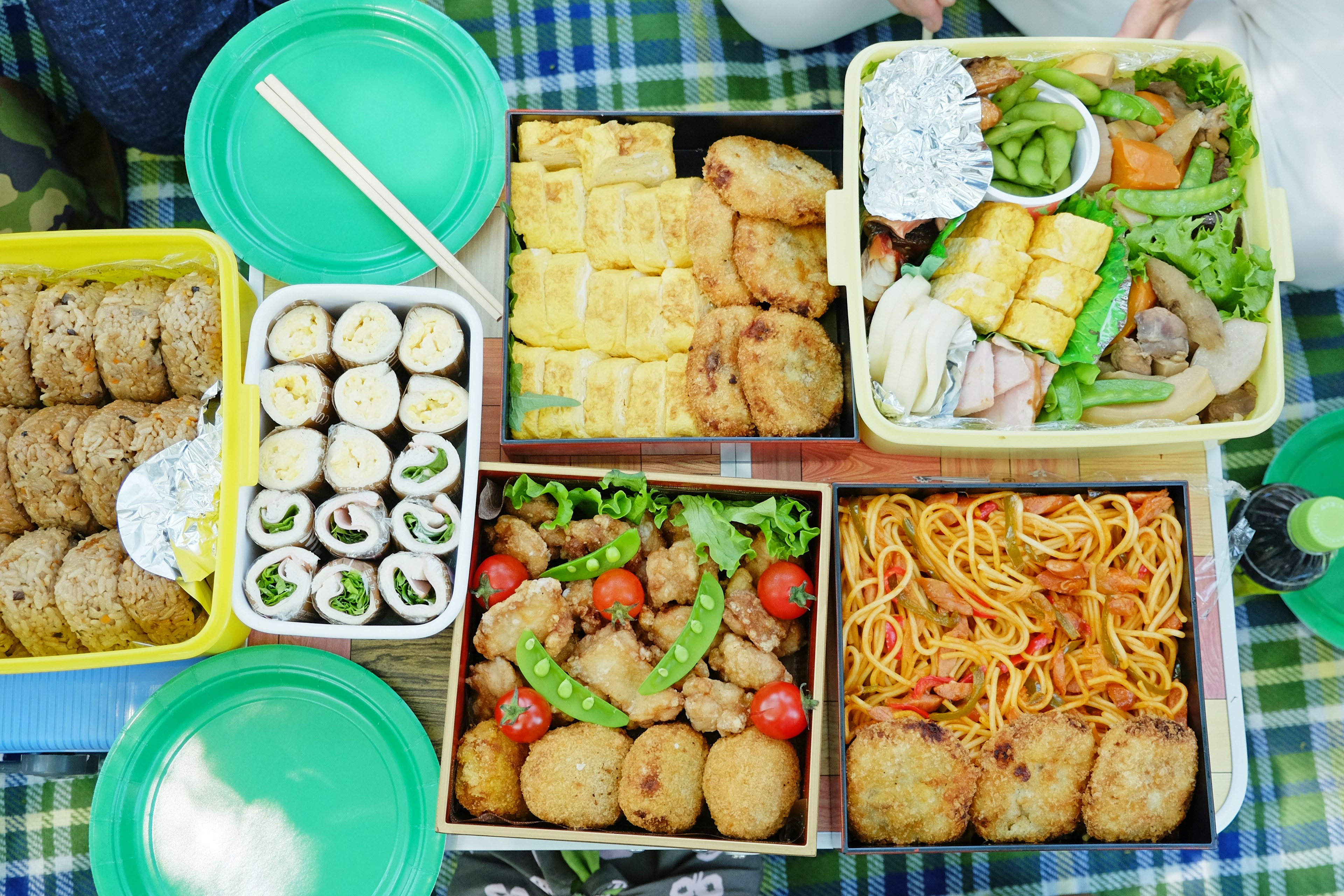 A colorful assortment of dishes in lunch boxes