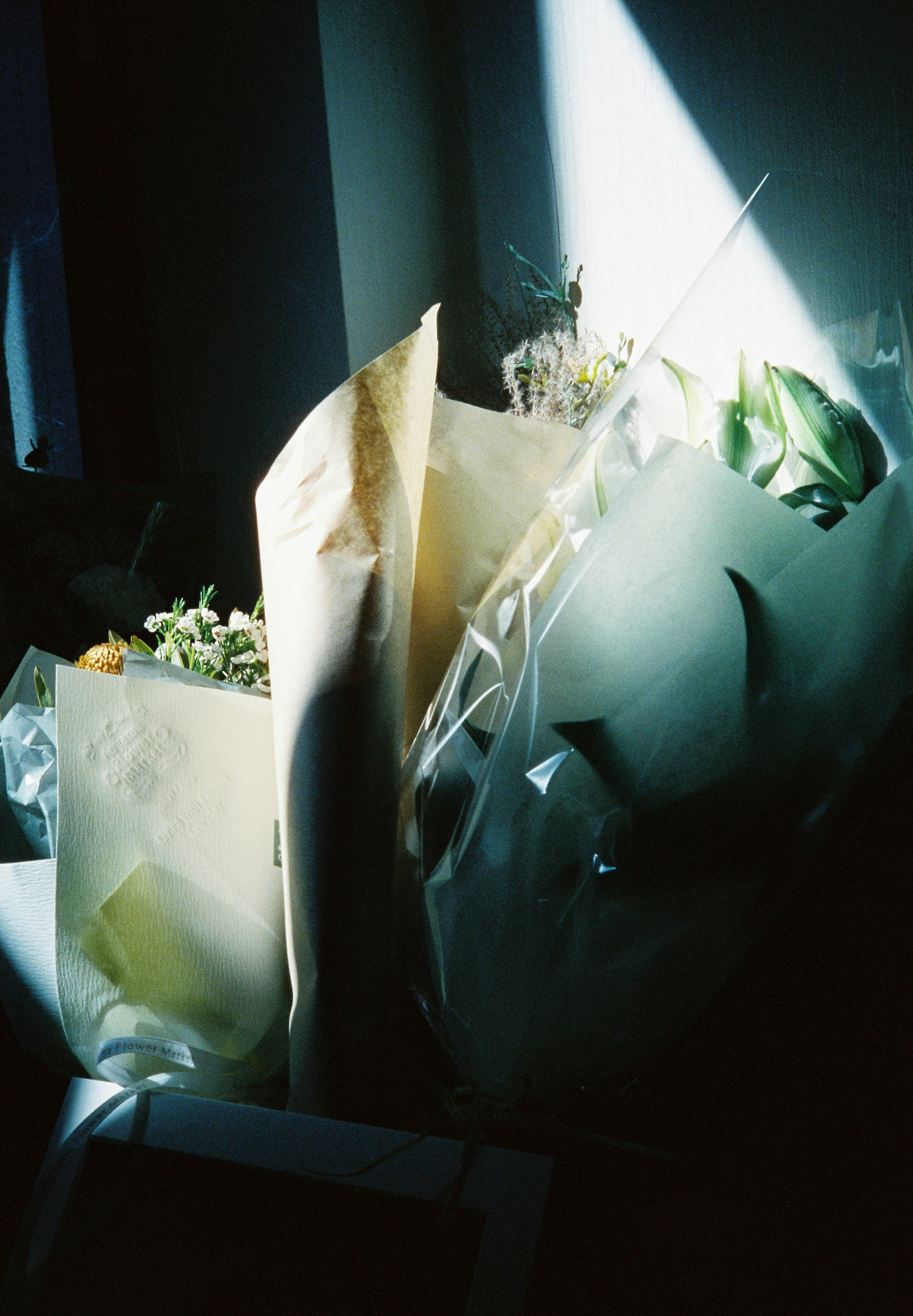 A photo of flower bouquets arranged with light streaming in