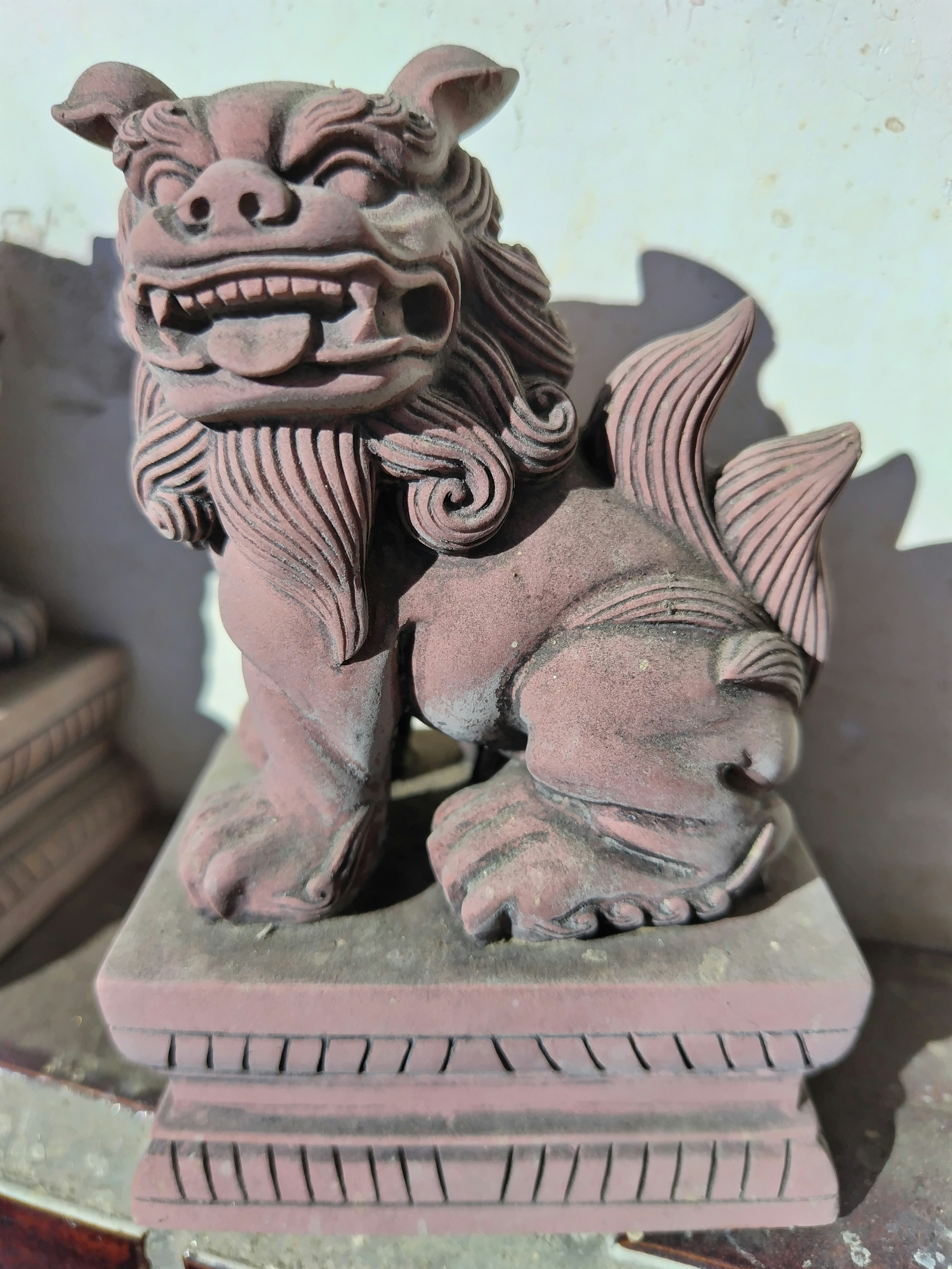 Detailed sculpture of a lion figure with expressive features