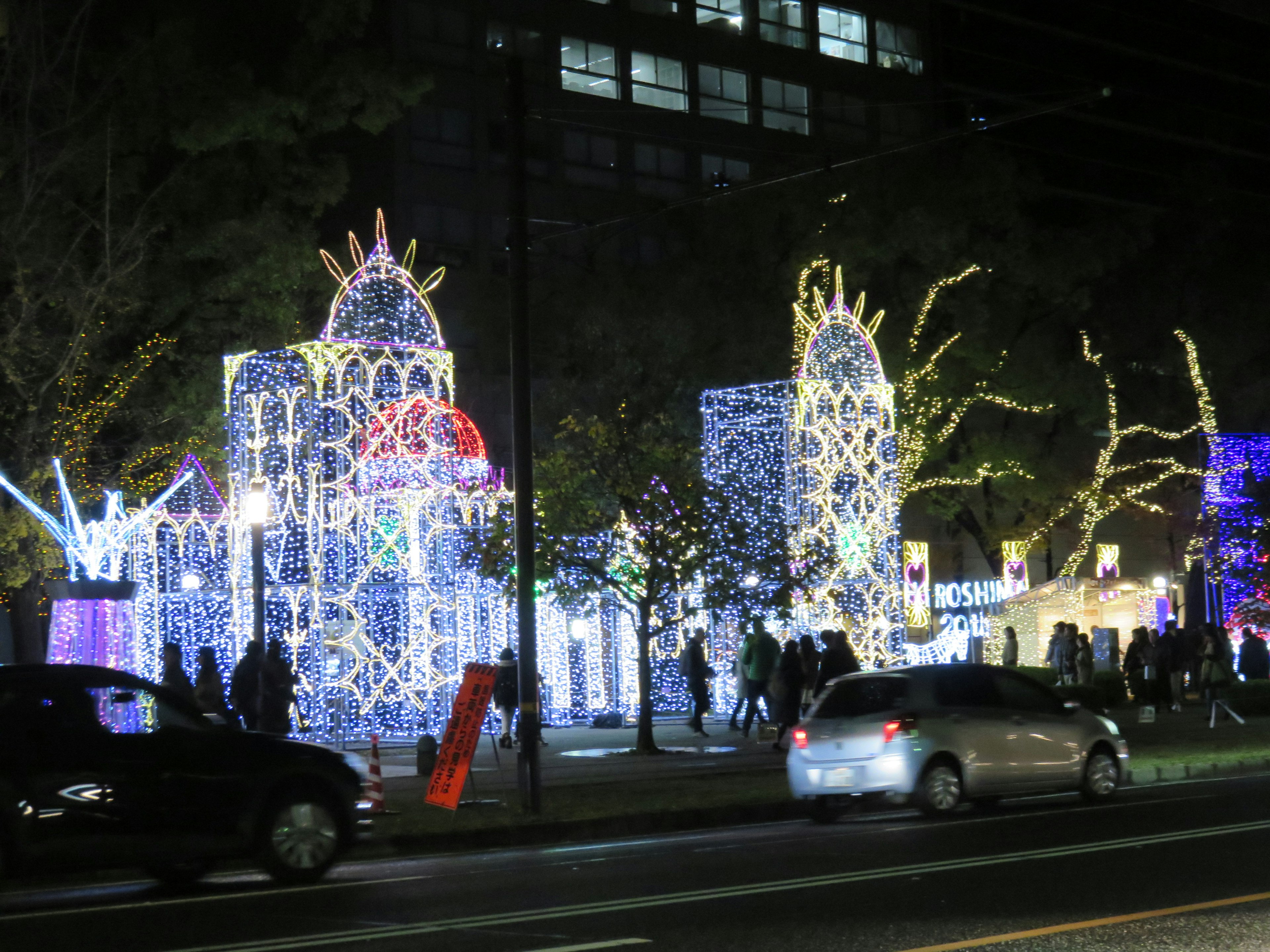 Illuminated buildings and people in a vibrant night scene