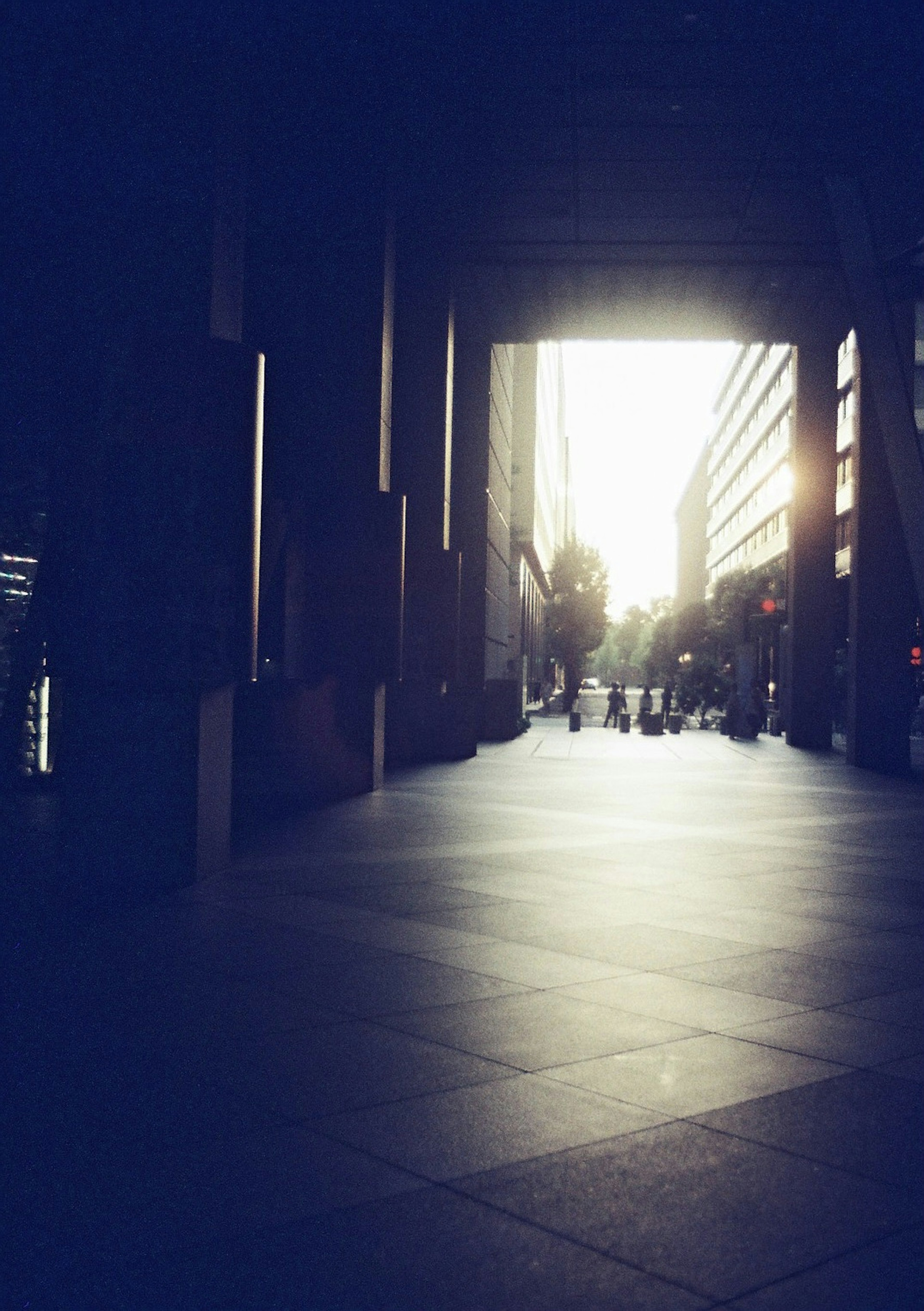 Urban scene with a dark corridor leading to bright light