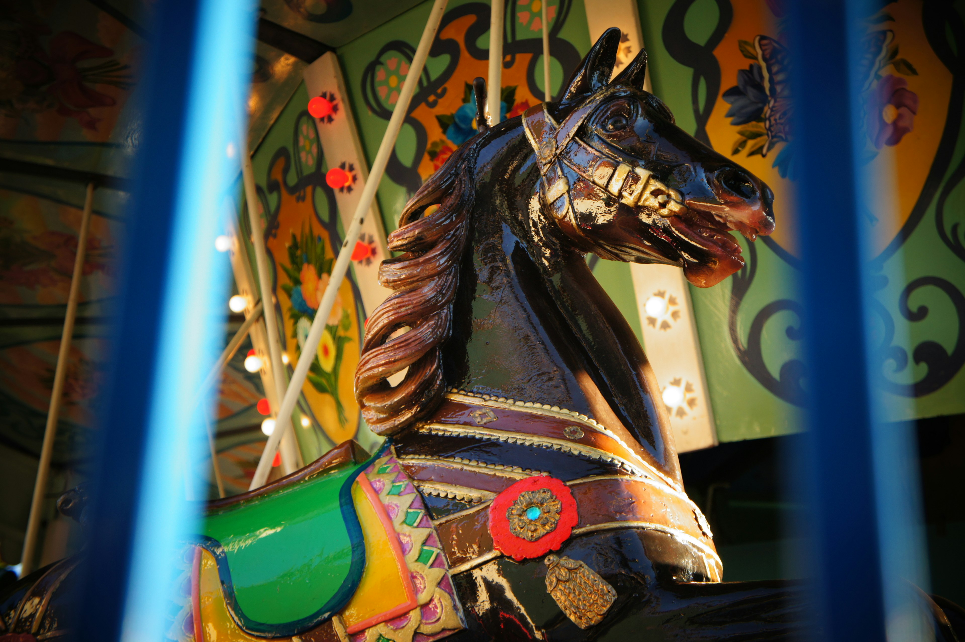 A colorful carousel horse head with intricate details and vibrant colors