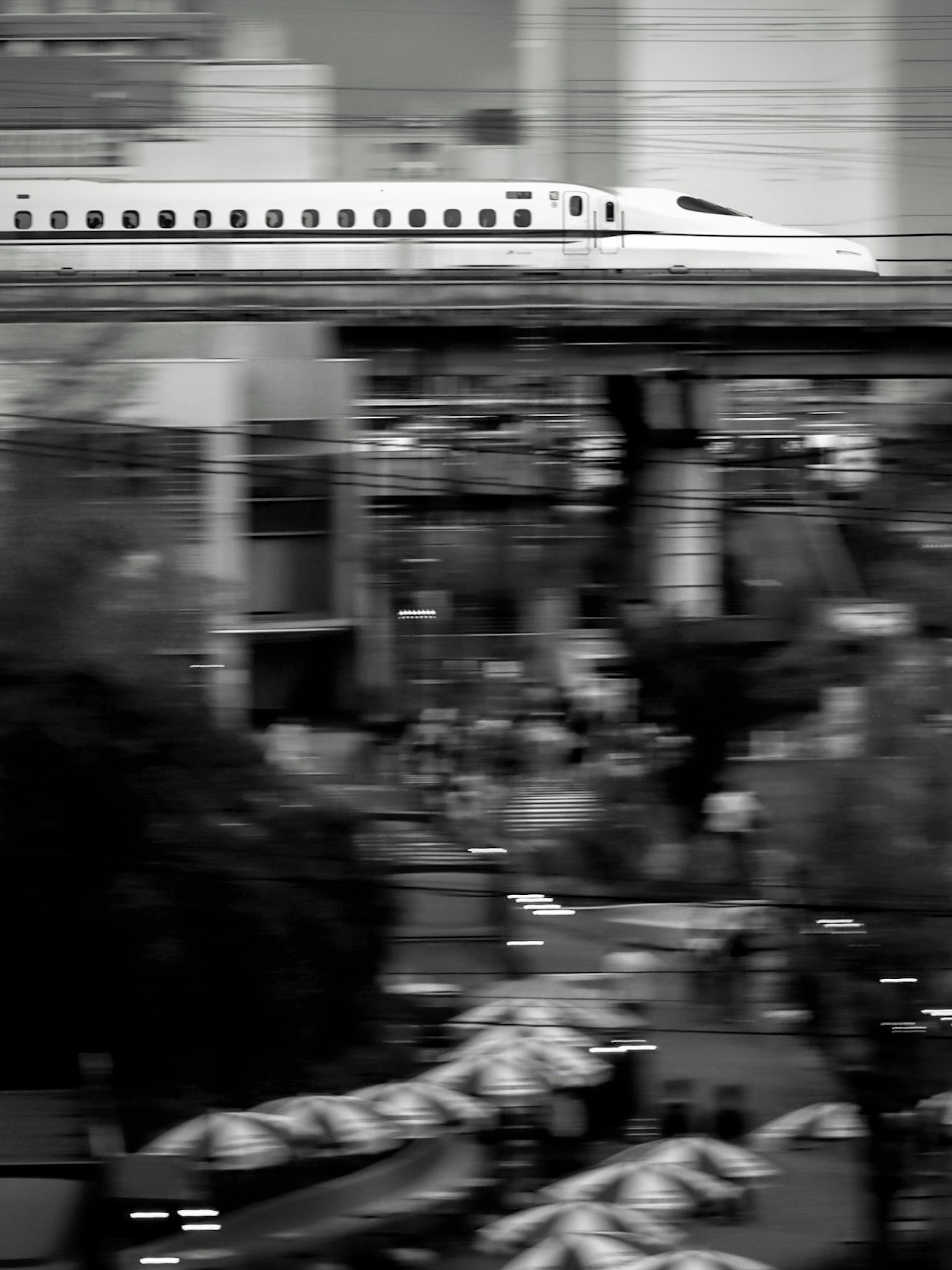 Shinkansen train speeding through a bustling urban landscape