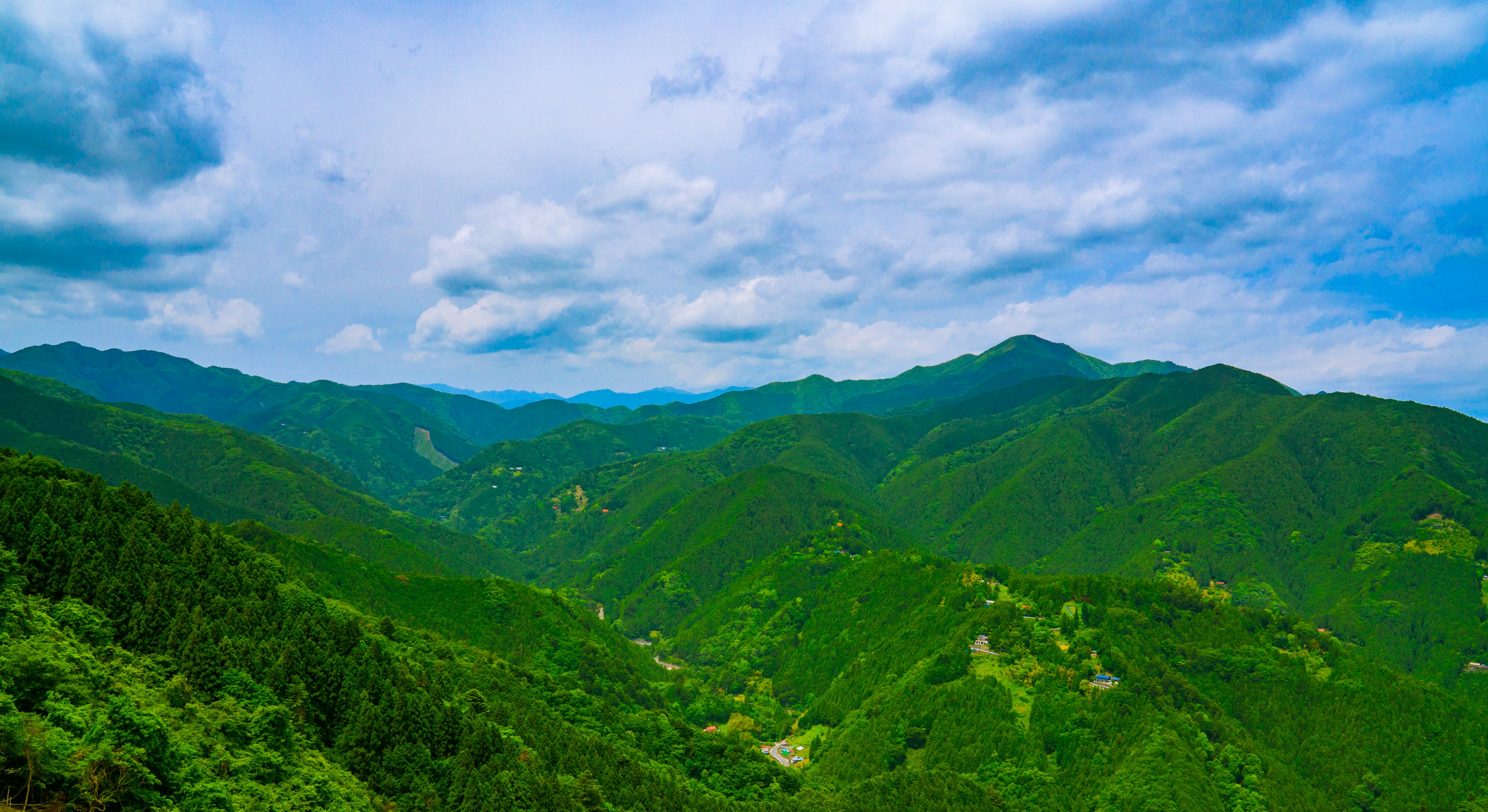 Lush green mountains under a blue sky