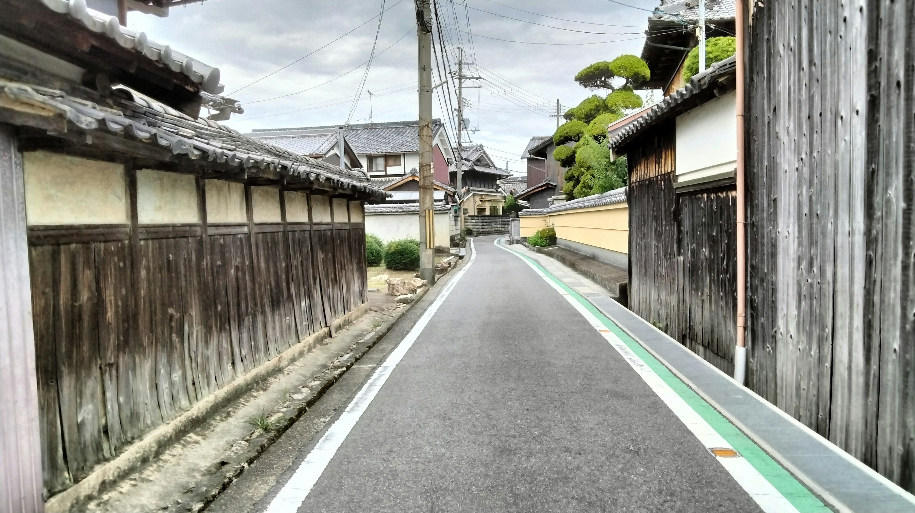 Narrow street lined with old wooden buildings