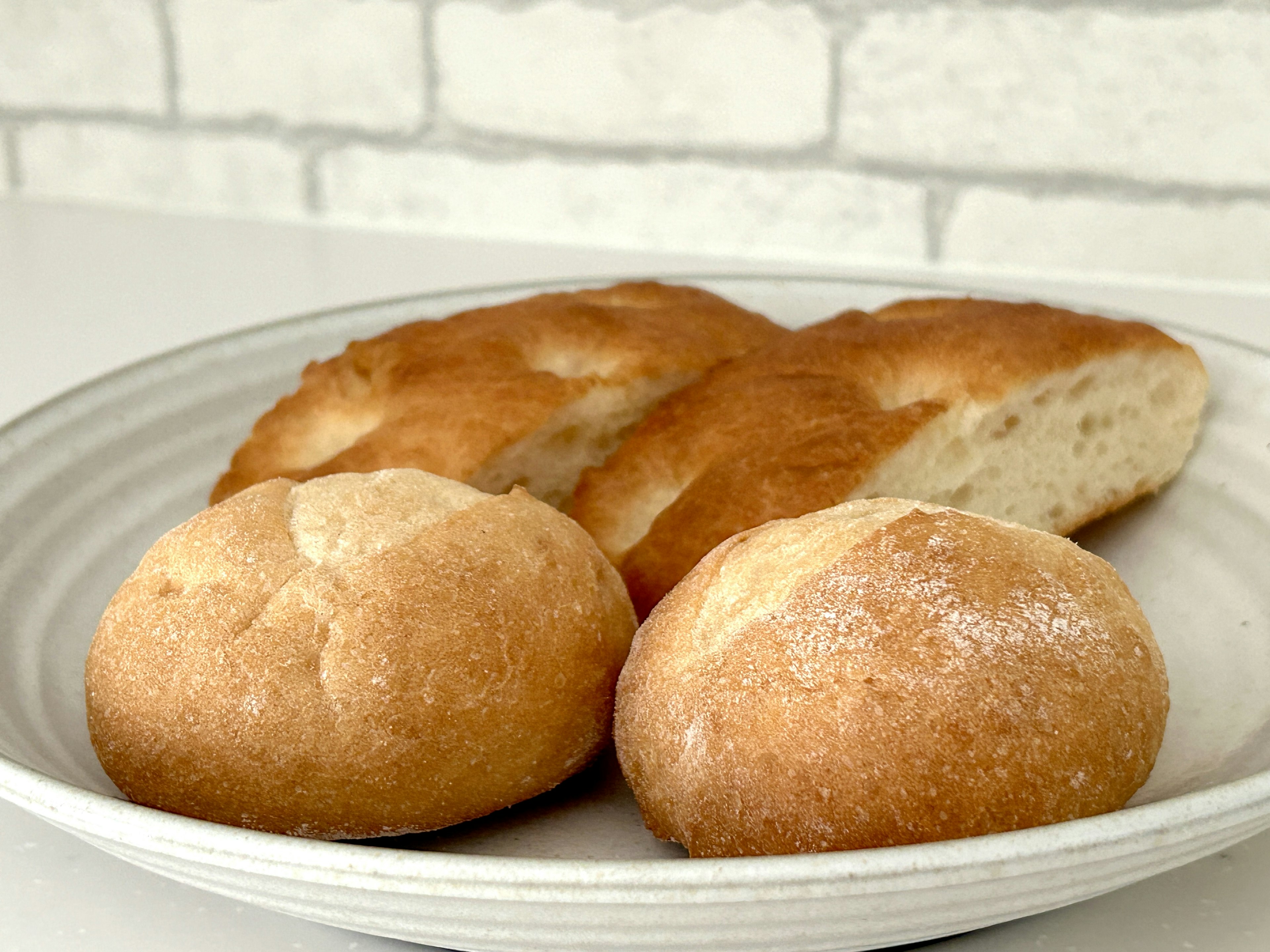 Freshly baked bread assortment on a white plate