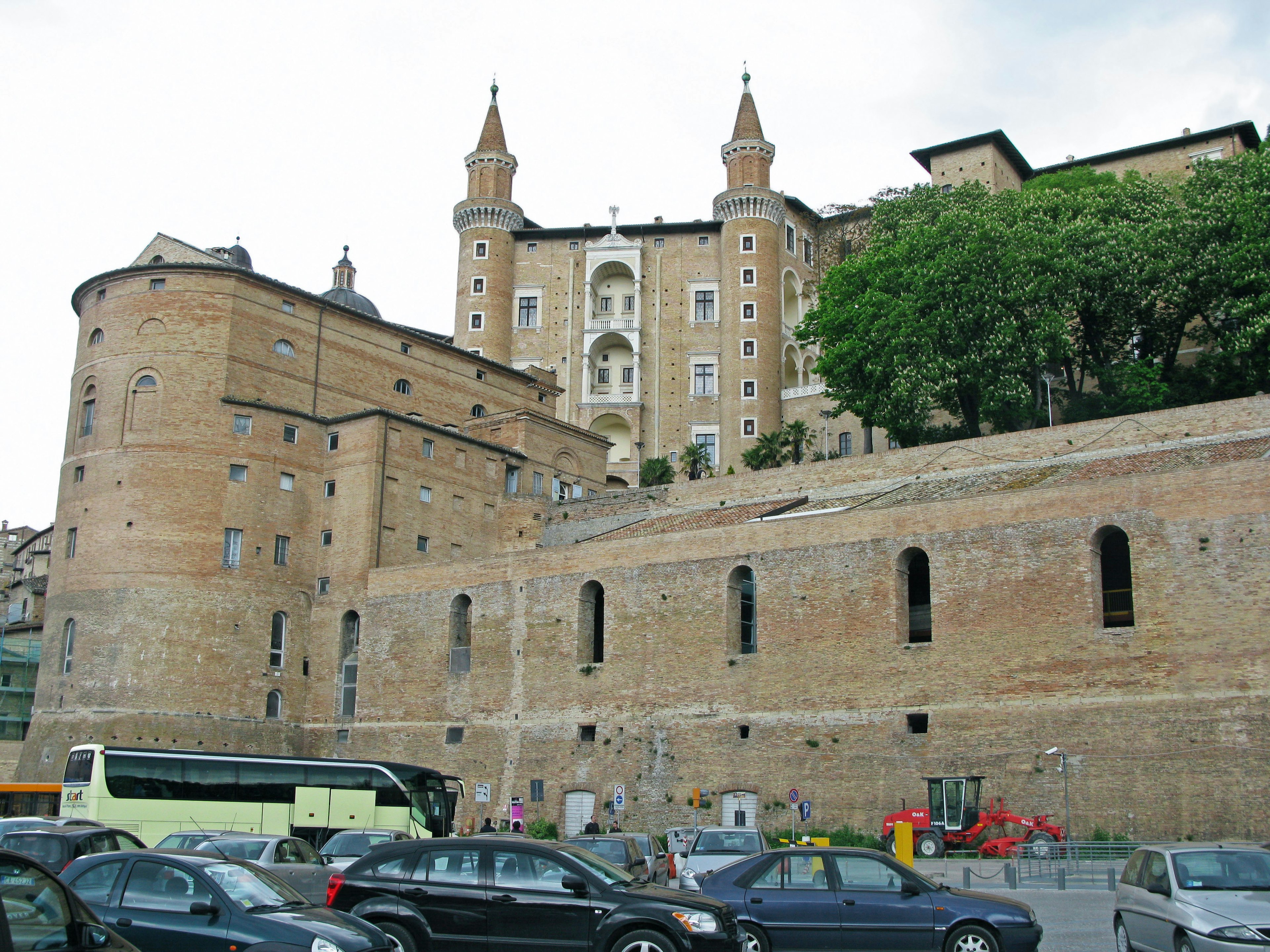 View of historic buildings with ancient walls and trees