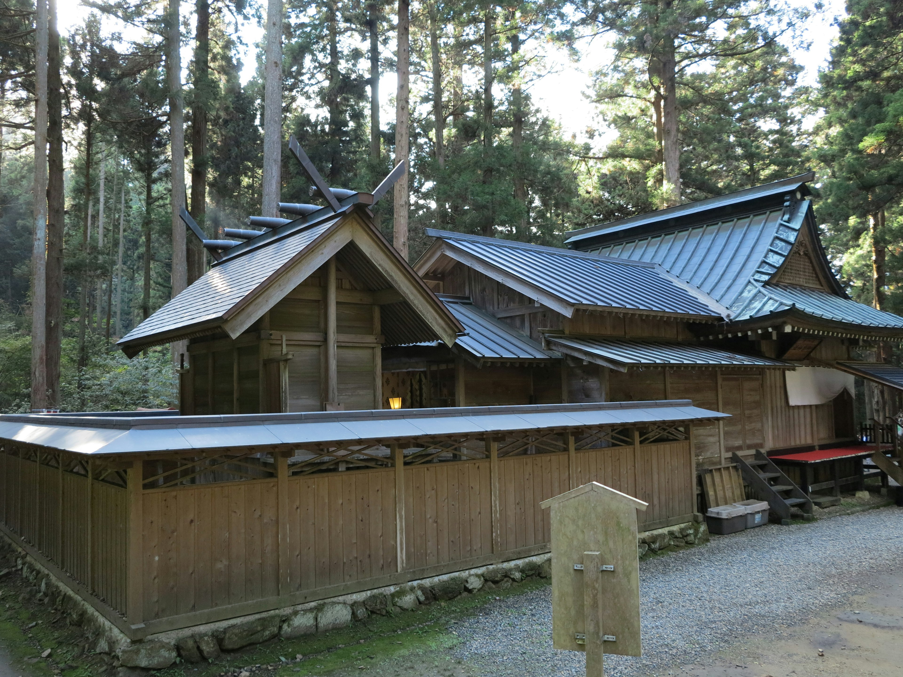 Traditional Japanese shrine building nestled in a forest