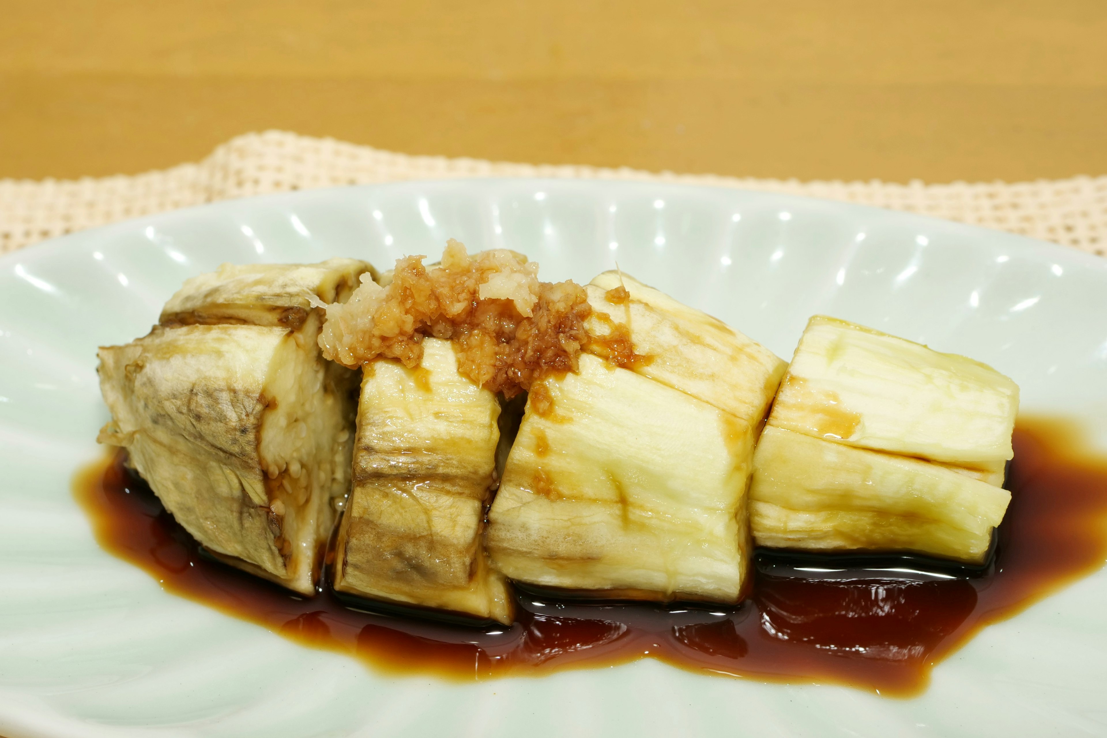 Sliced eggplant drizzled with sweet savory sauce