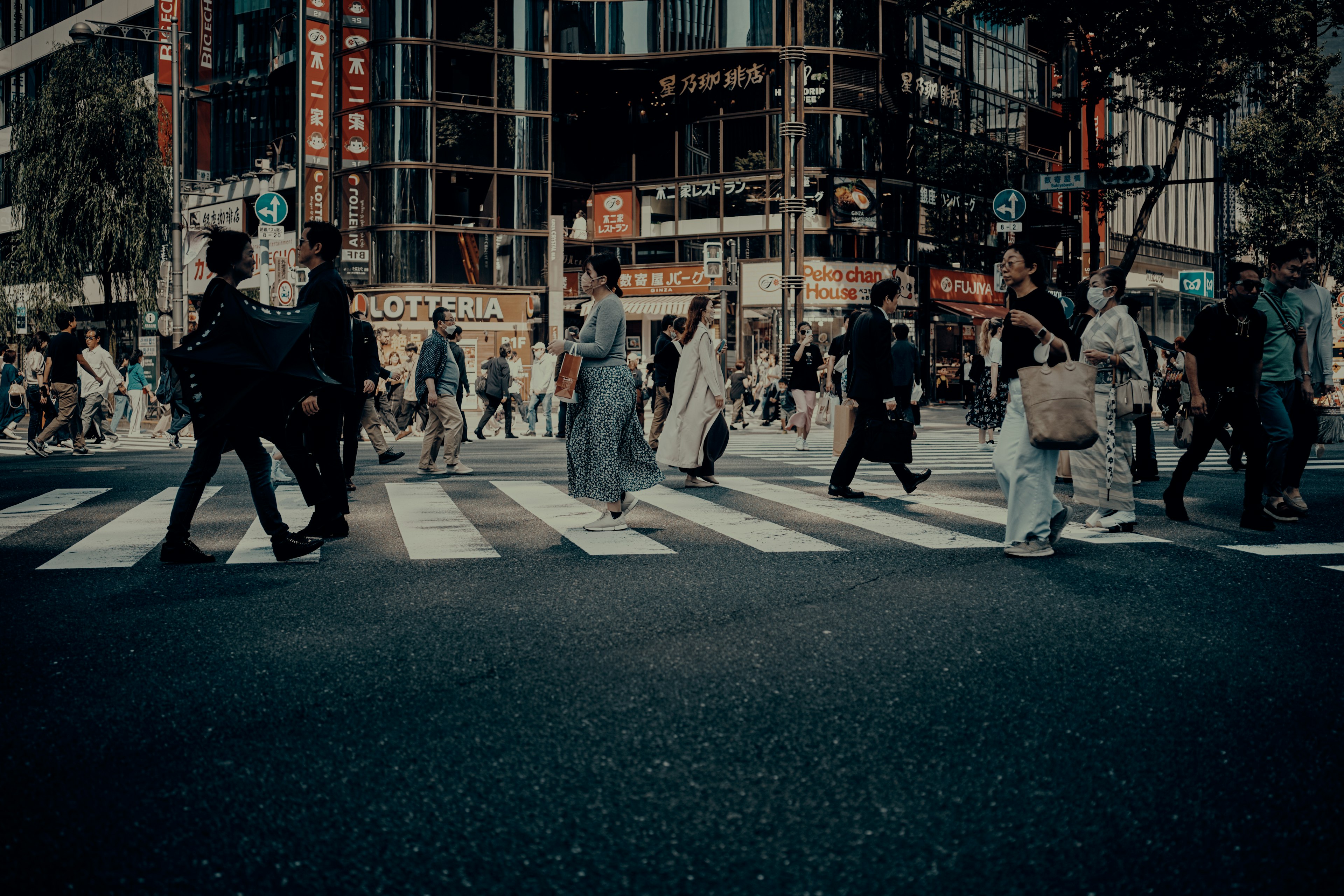 人々が交差点を渡る都市の風景