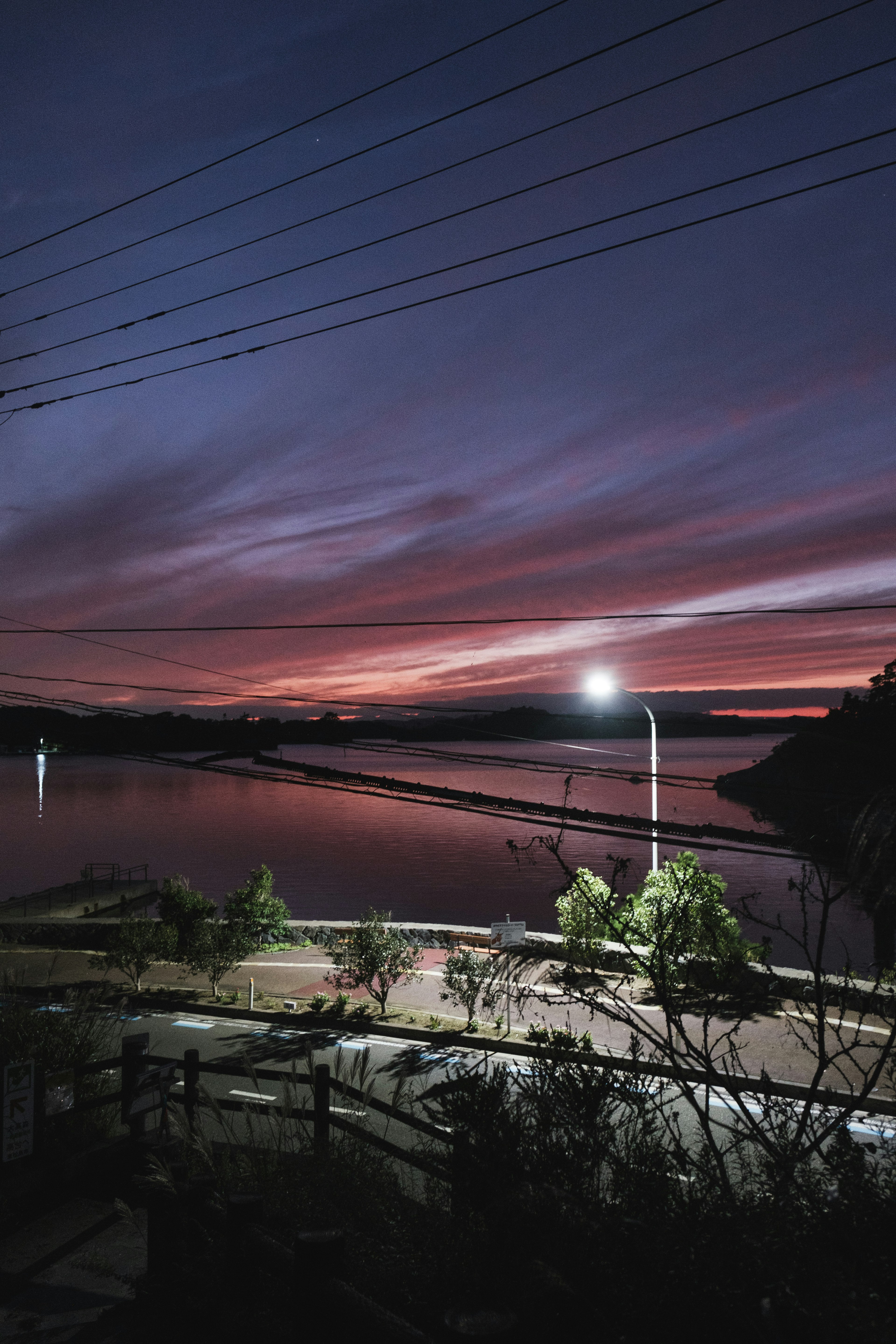 Lake view at sunset with vibrant colors and streetlight