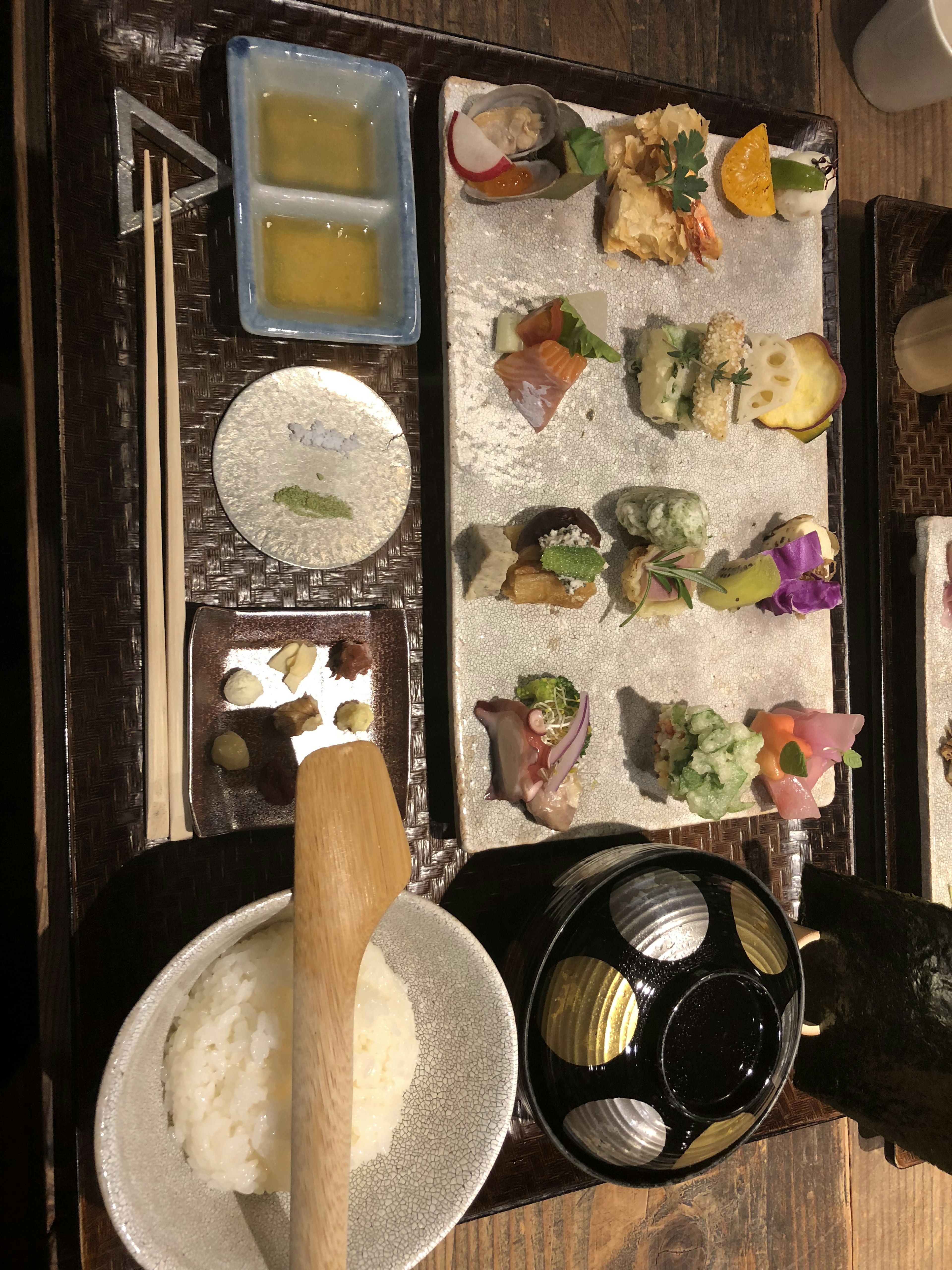 Beautiful sushi platter with various toppings and a bowl of rice