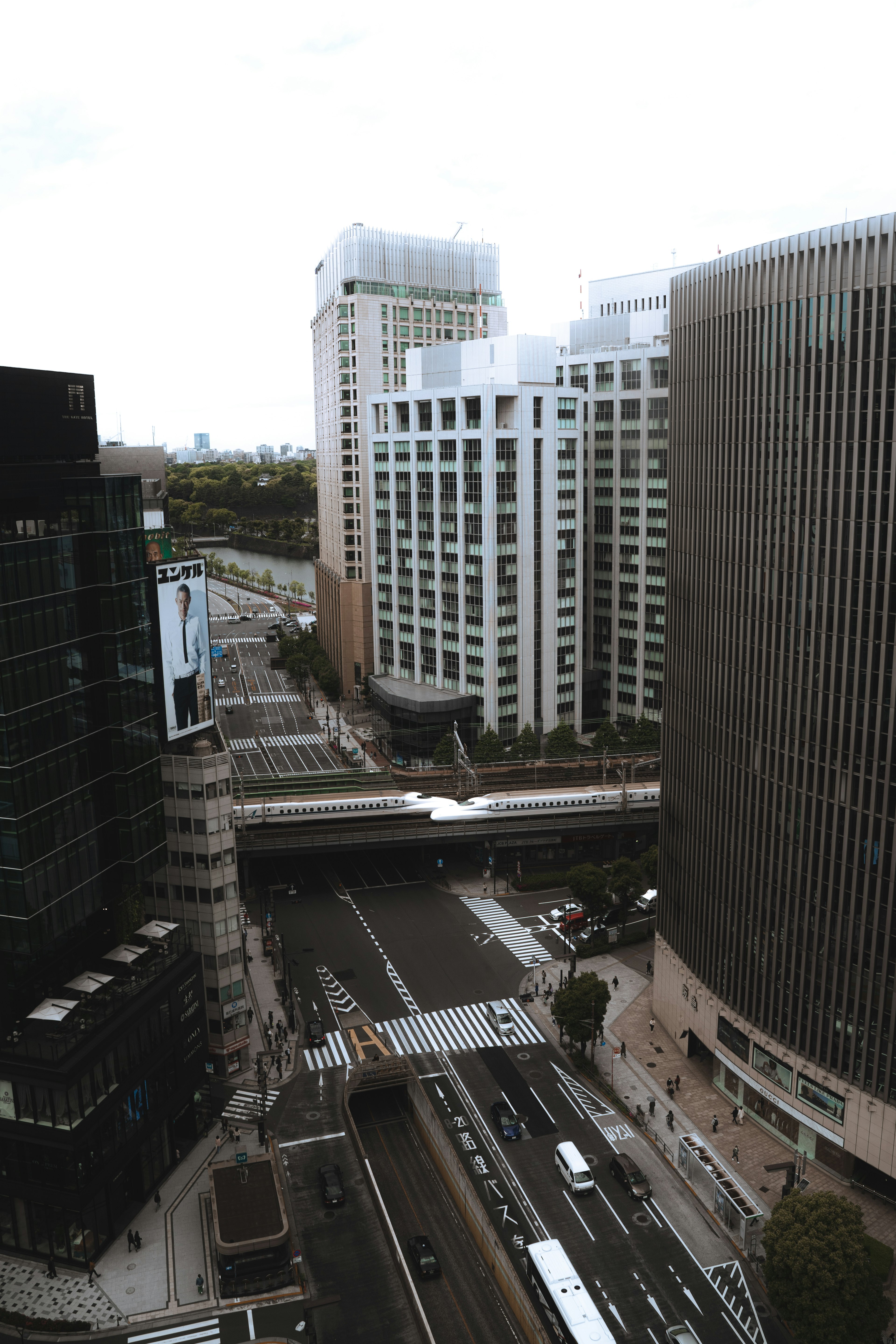 Urban landscape featuring tall buildings and a busy road intersection