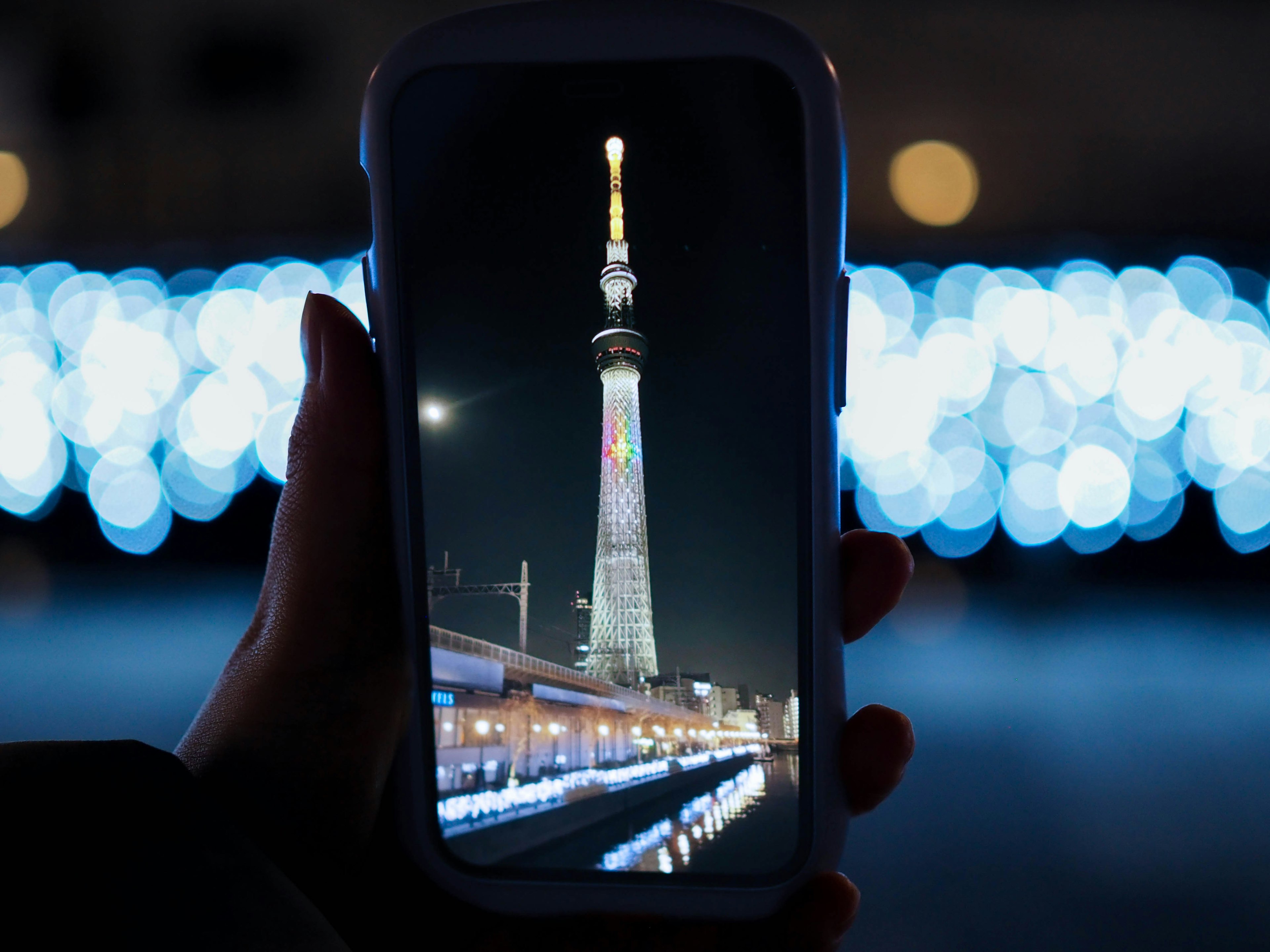 A smartphone displaying a night view of Tokyo Skytree