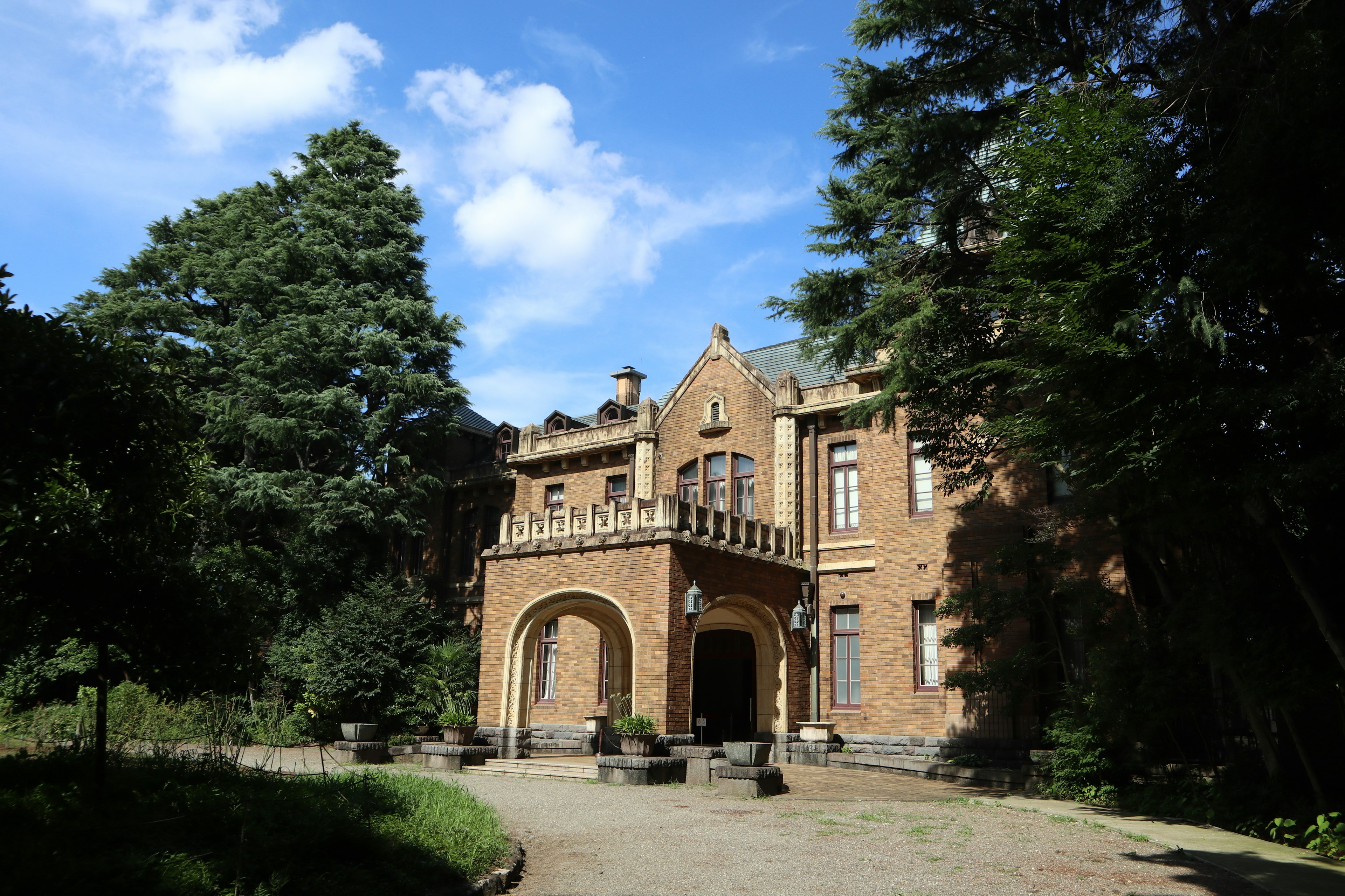 Beautiful red brick building surrounded by lush greenery