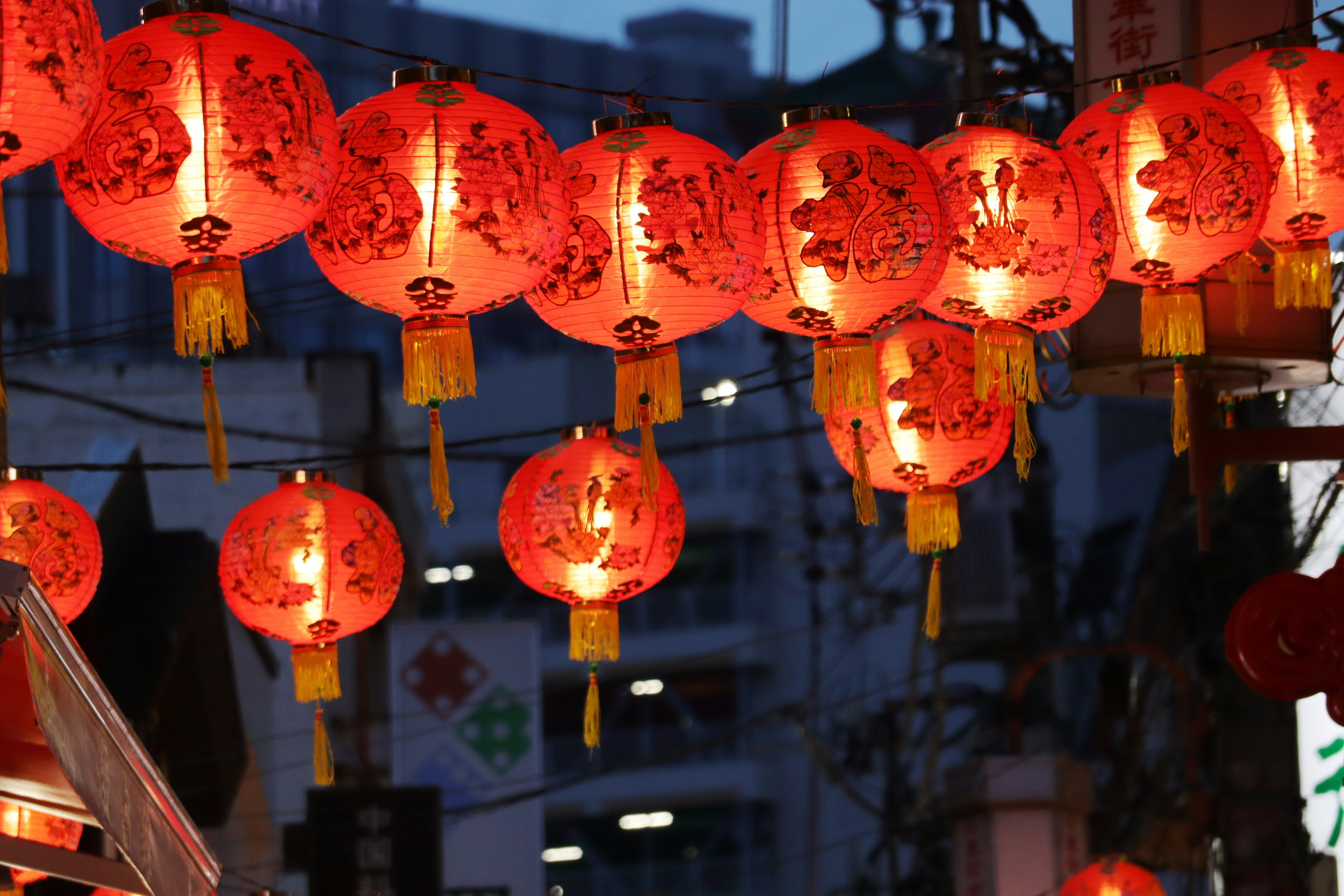 Row of red lanterns glowing in the night sky