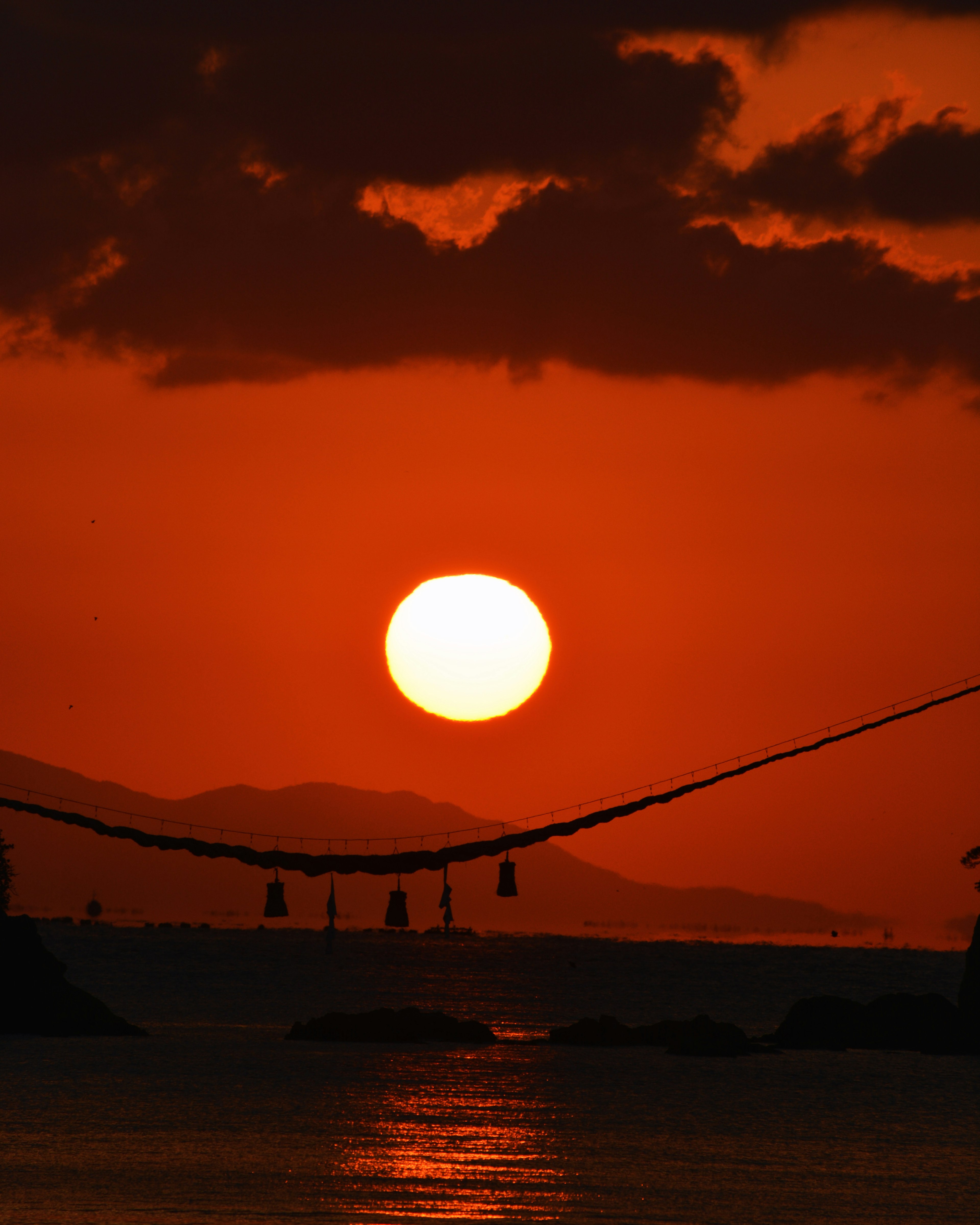 夕日が赤く染まる海の景色とシルエットの風景