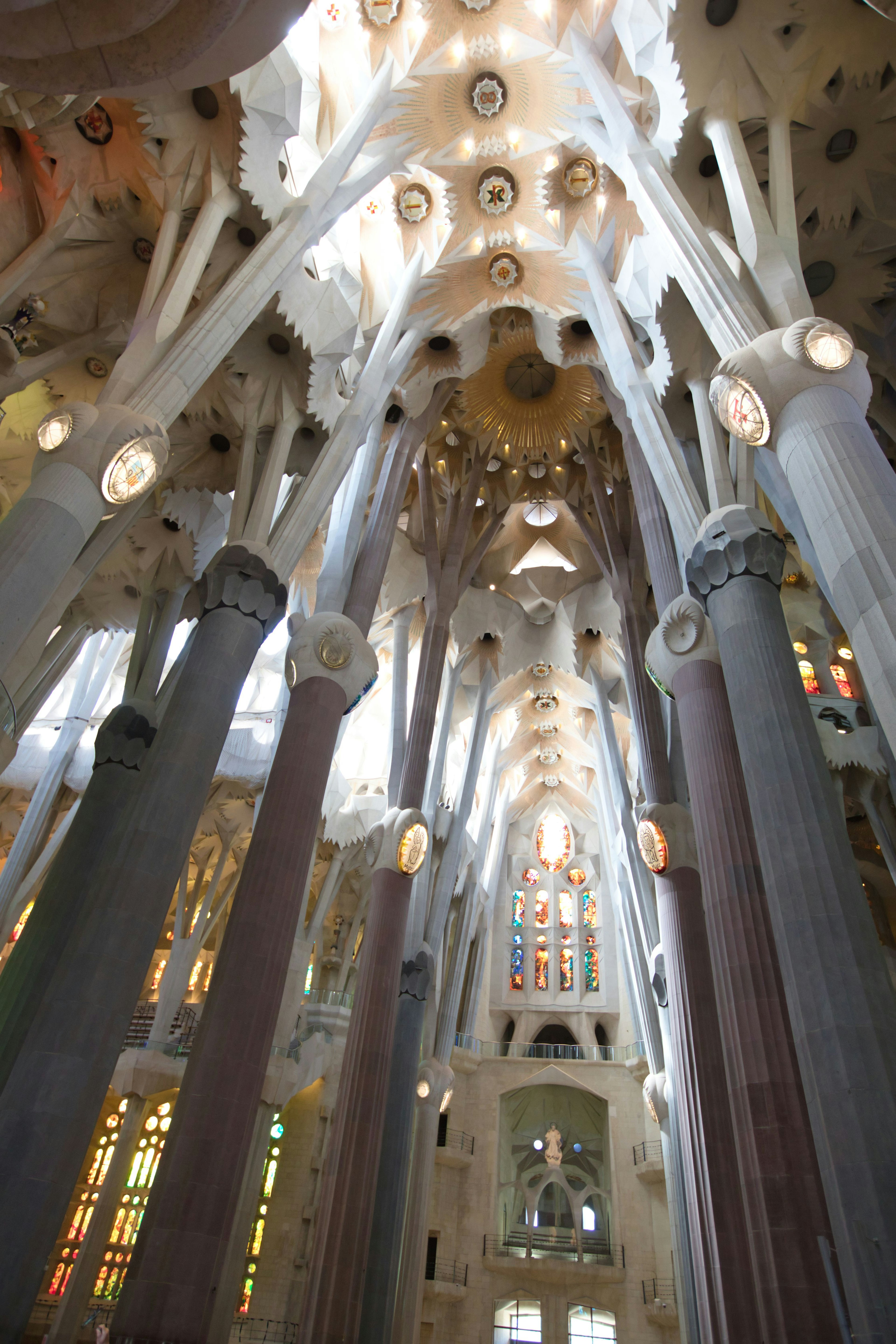 Interior view of Sagrada Familia showcasing stunning columns and light effects