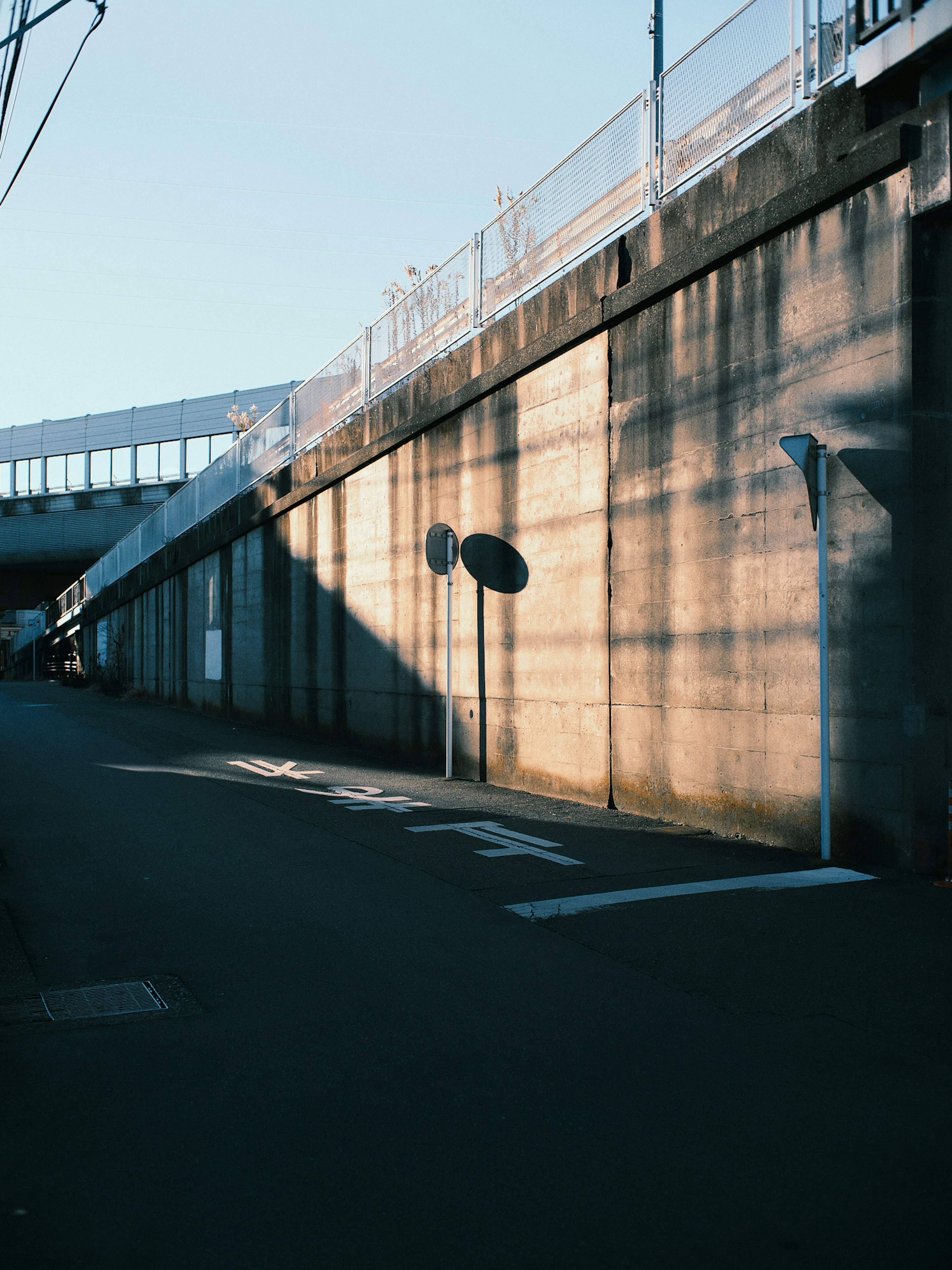 Concrete wall with shadows under blue sky