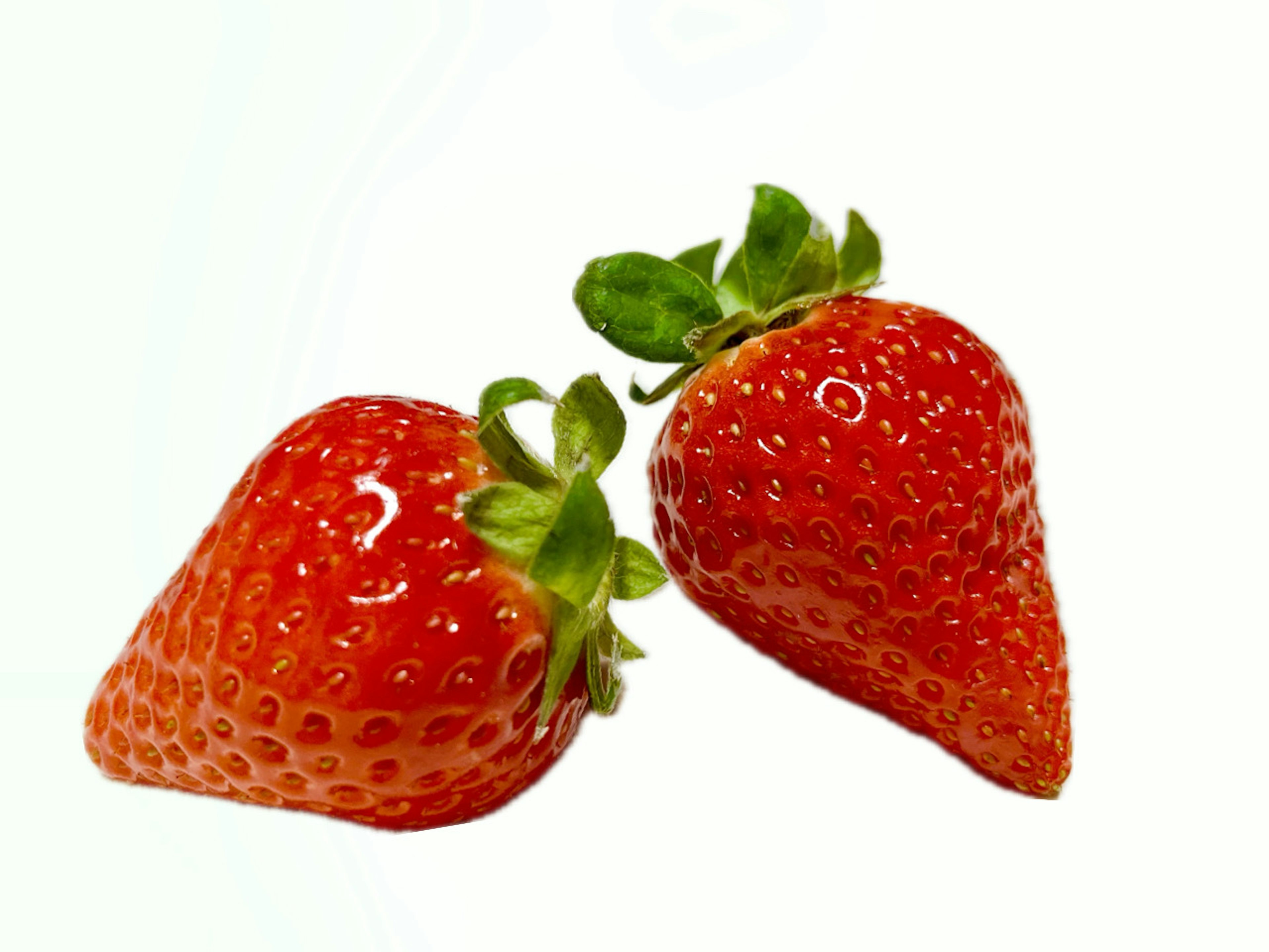 Two fresh strawberries on a white background