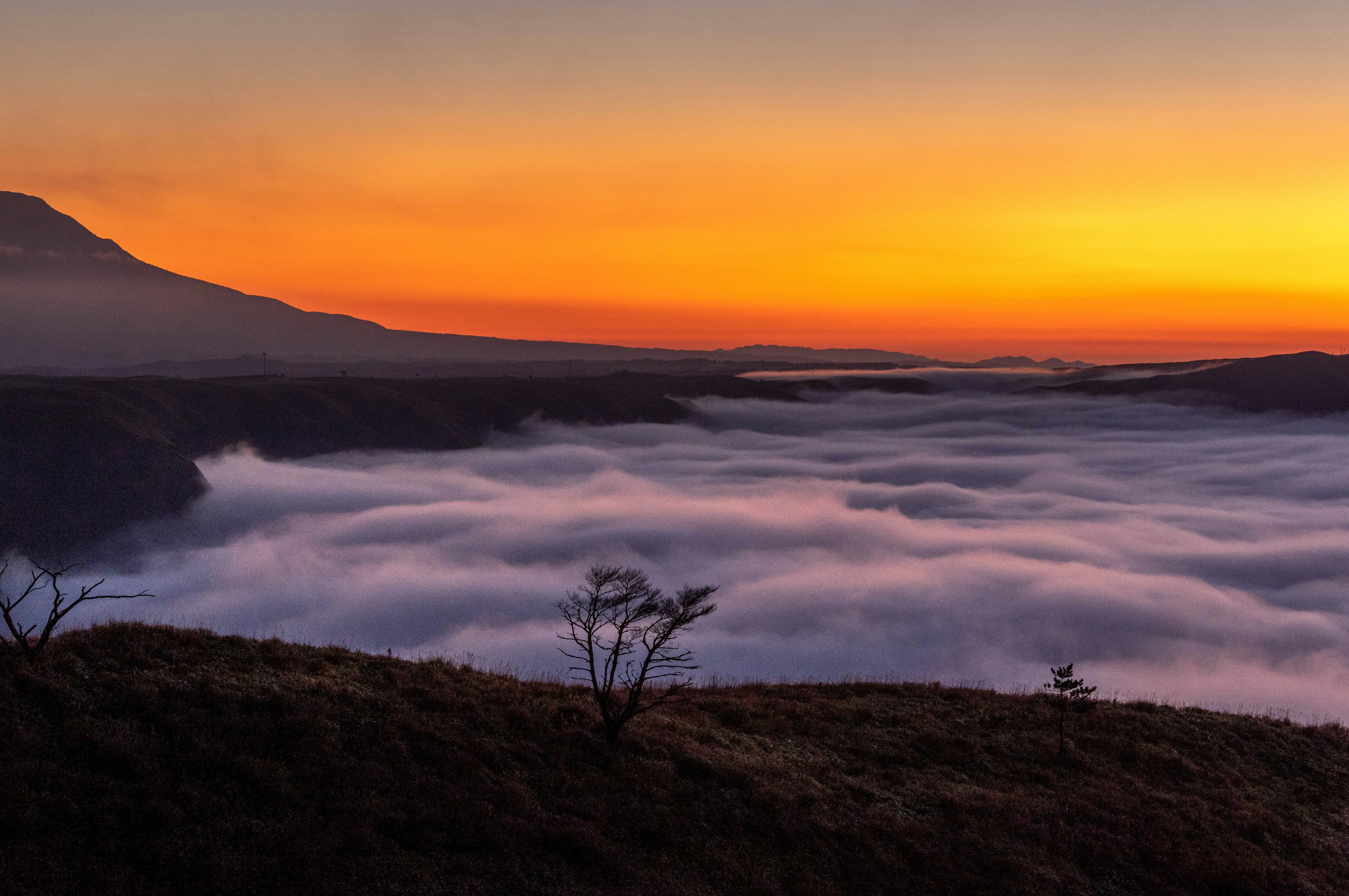 Mountain landscape with sunset sky and sea of clouds