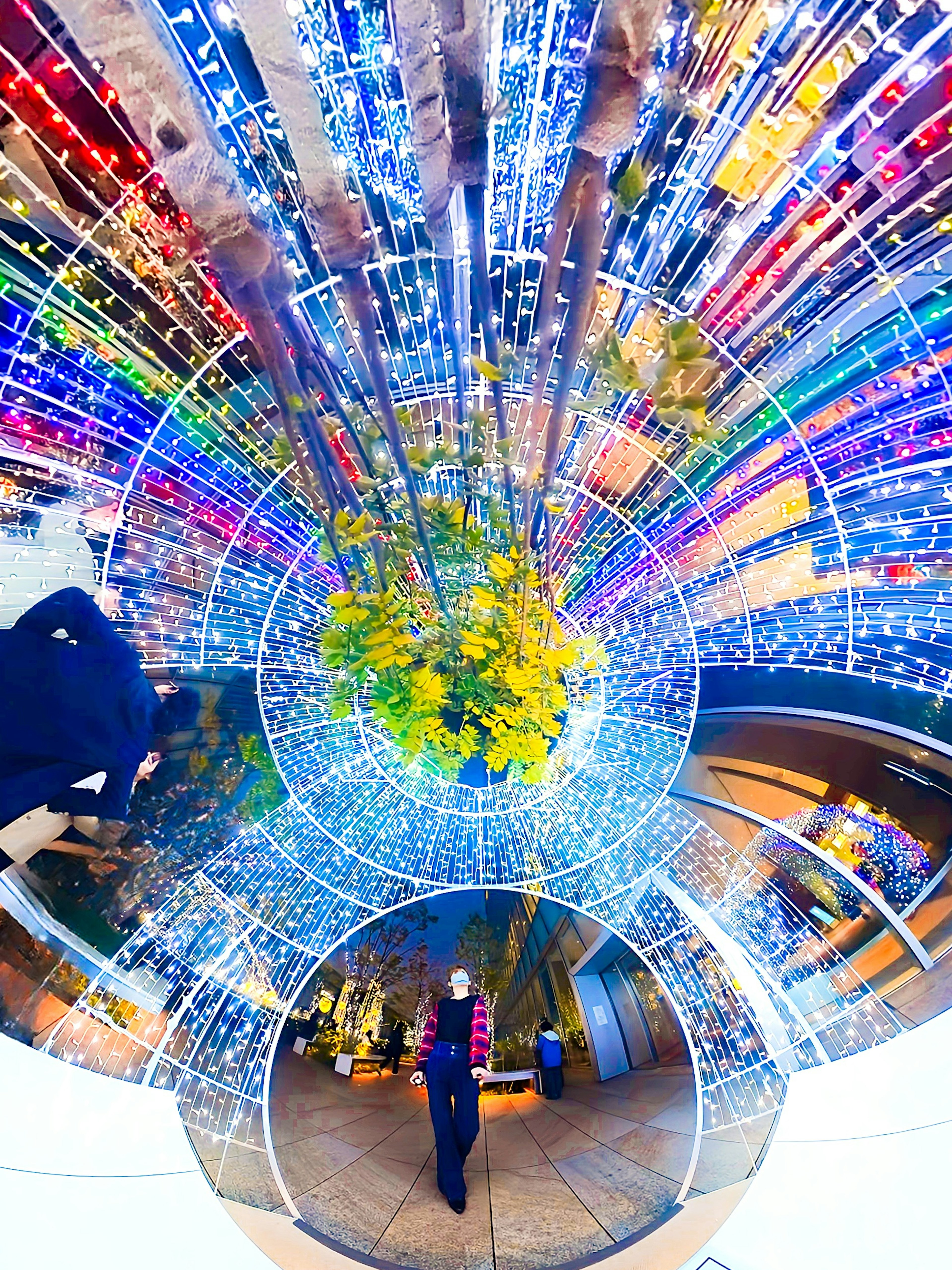 Personne se tenant dans un tunnel lumineux vibrant lumières colorées rayonnant vers l'extérieur