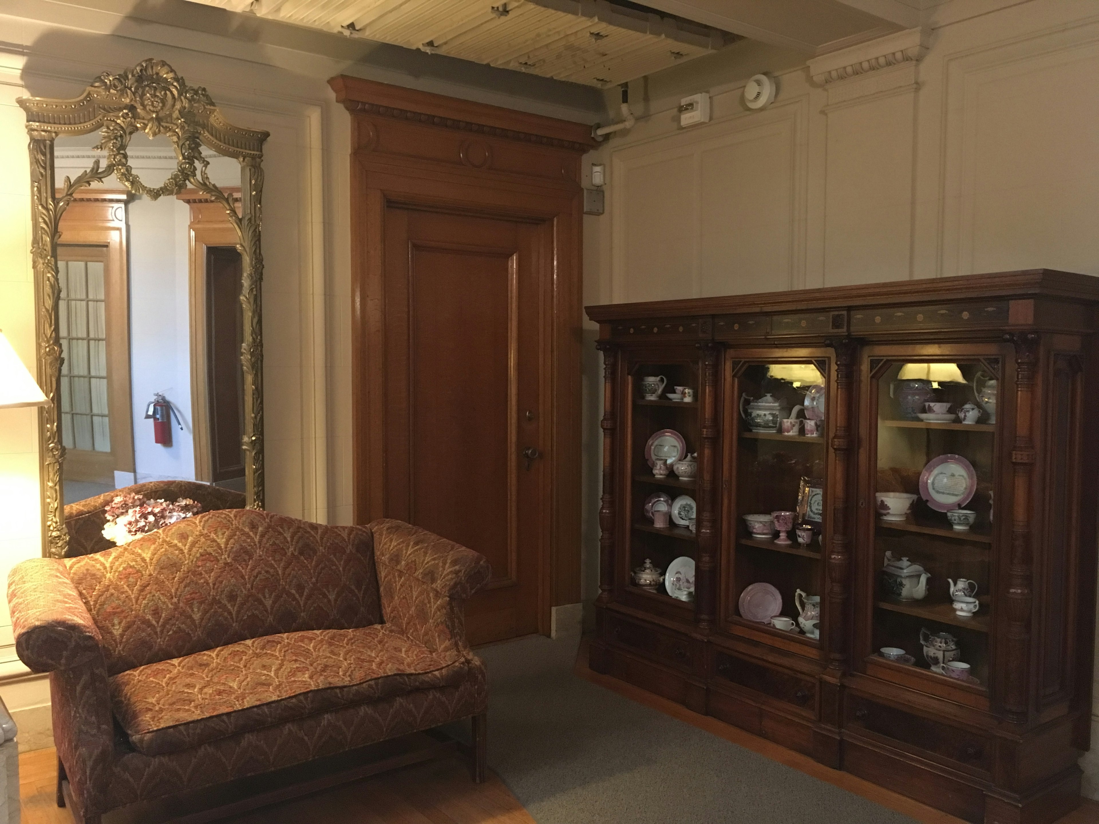 Interior of a room featuring a luxurious sofa and a display cabinet