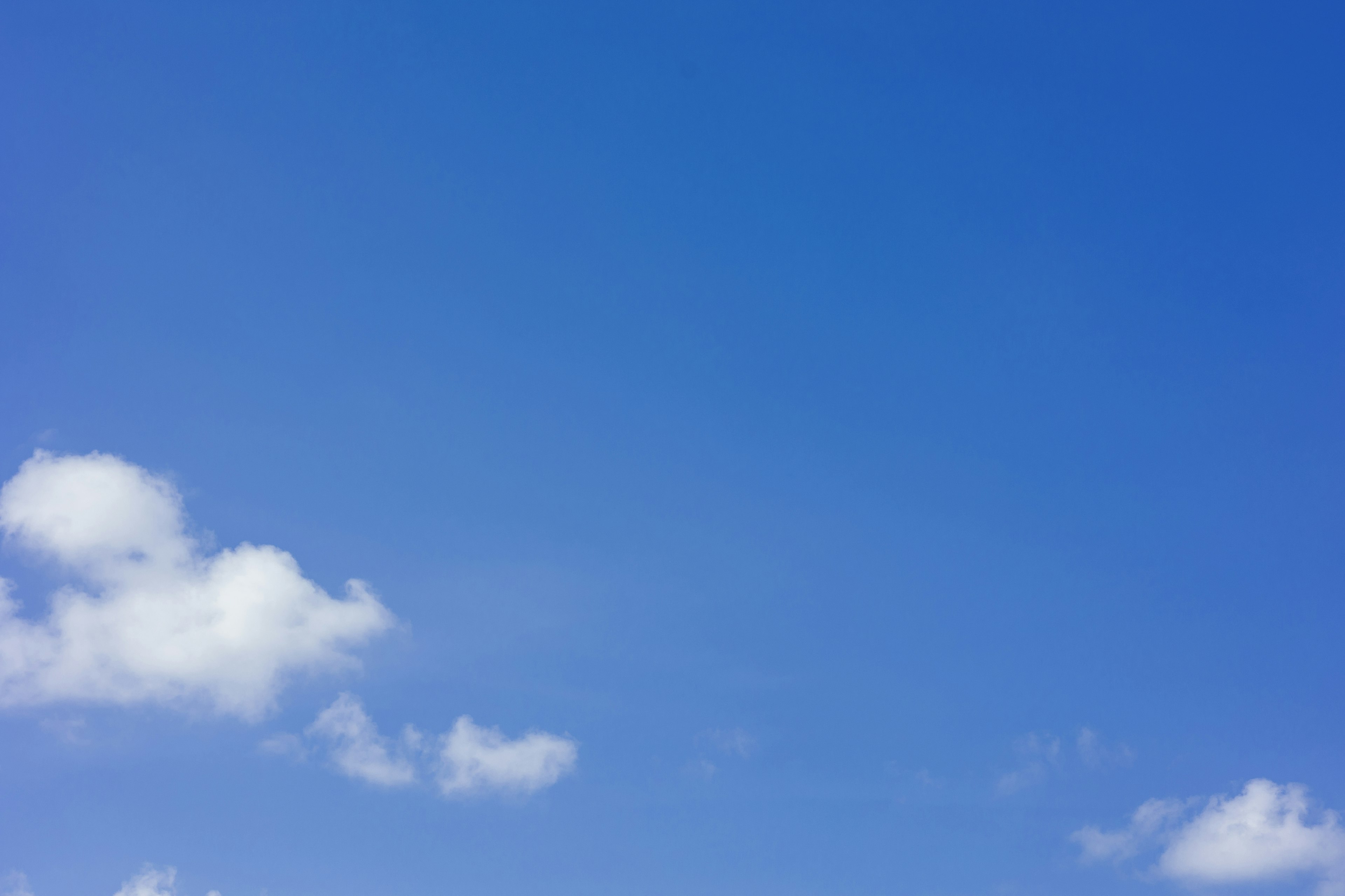 Bright blue sky with fluffy white clouds