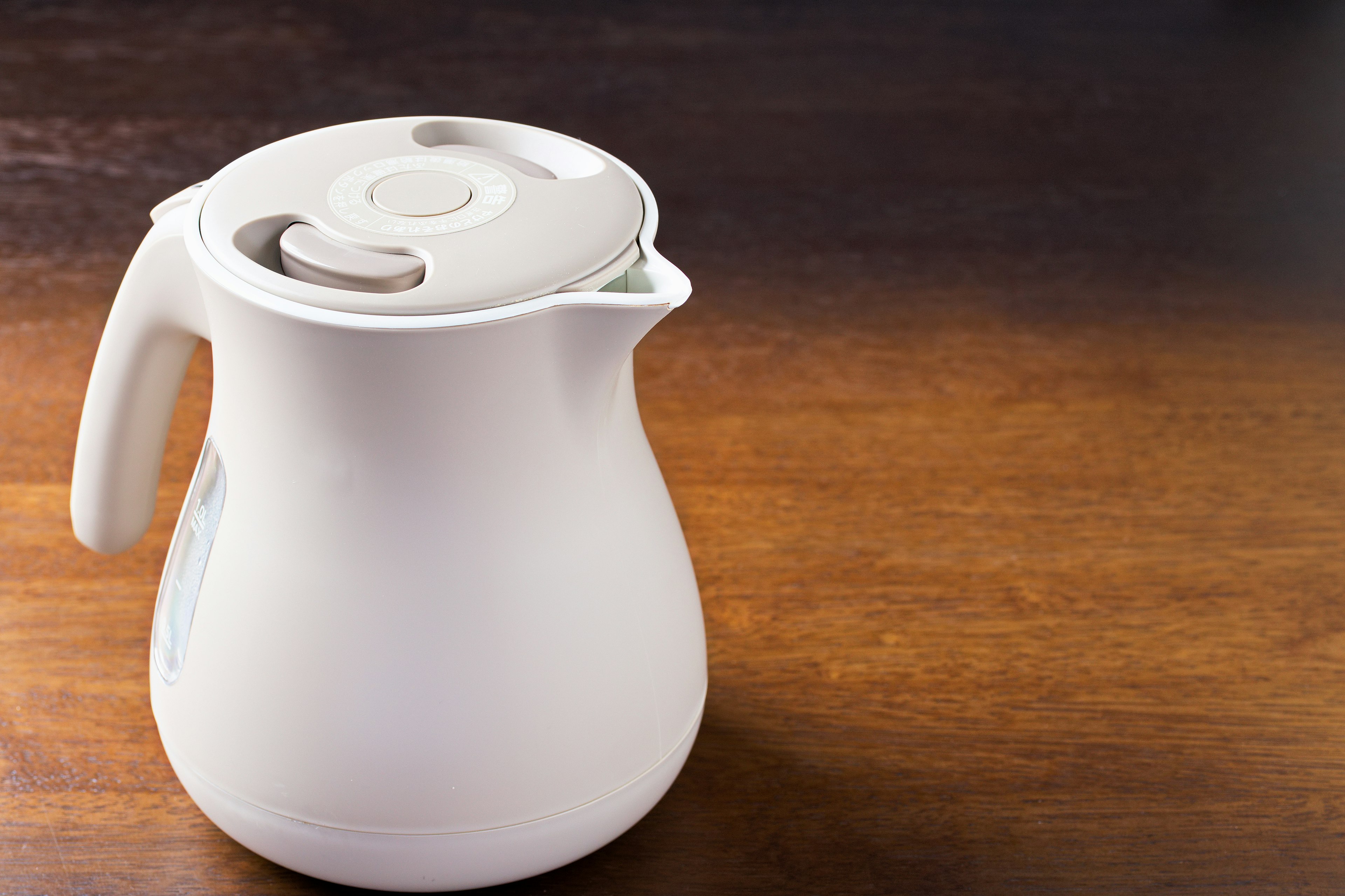 A simple and stylish white pitcher on a wooden table