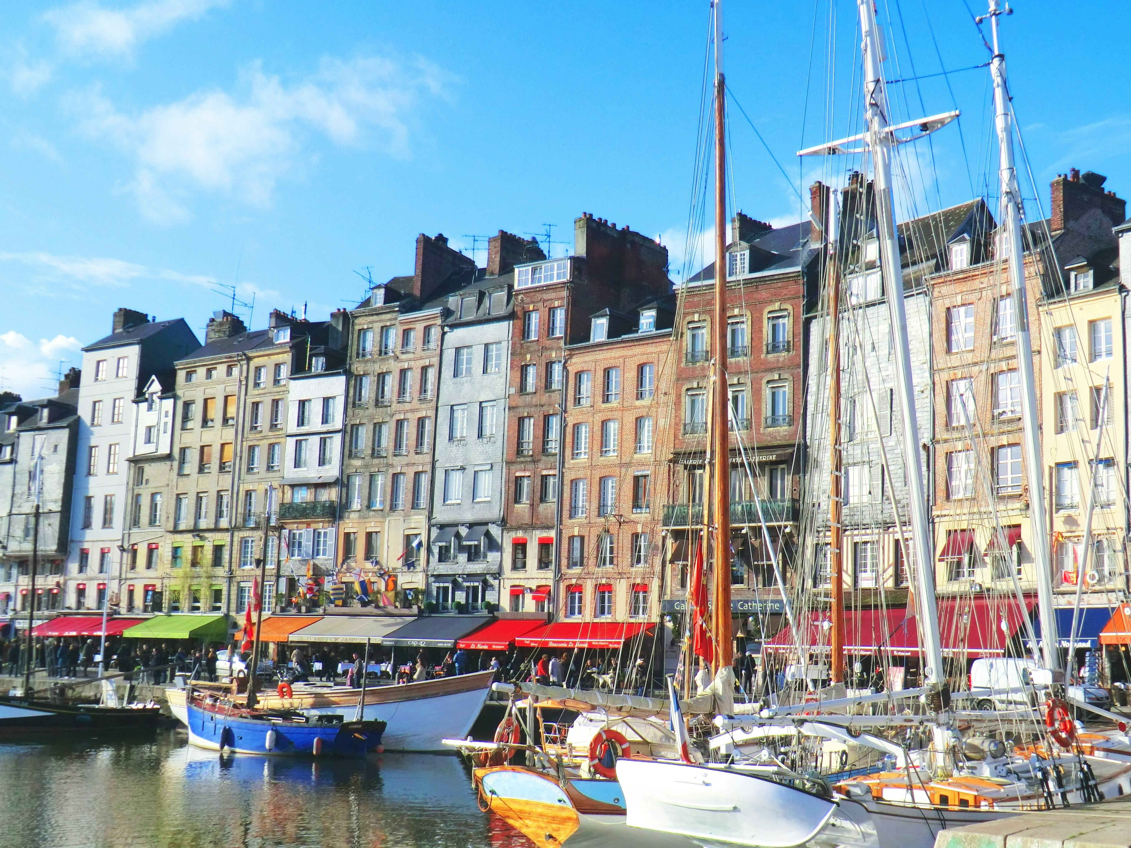 Harbor view featuring colorful buildings and yachts along the waterfront