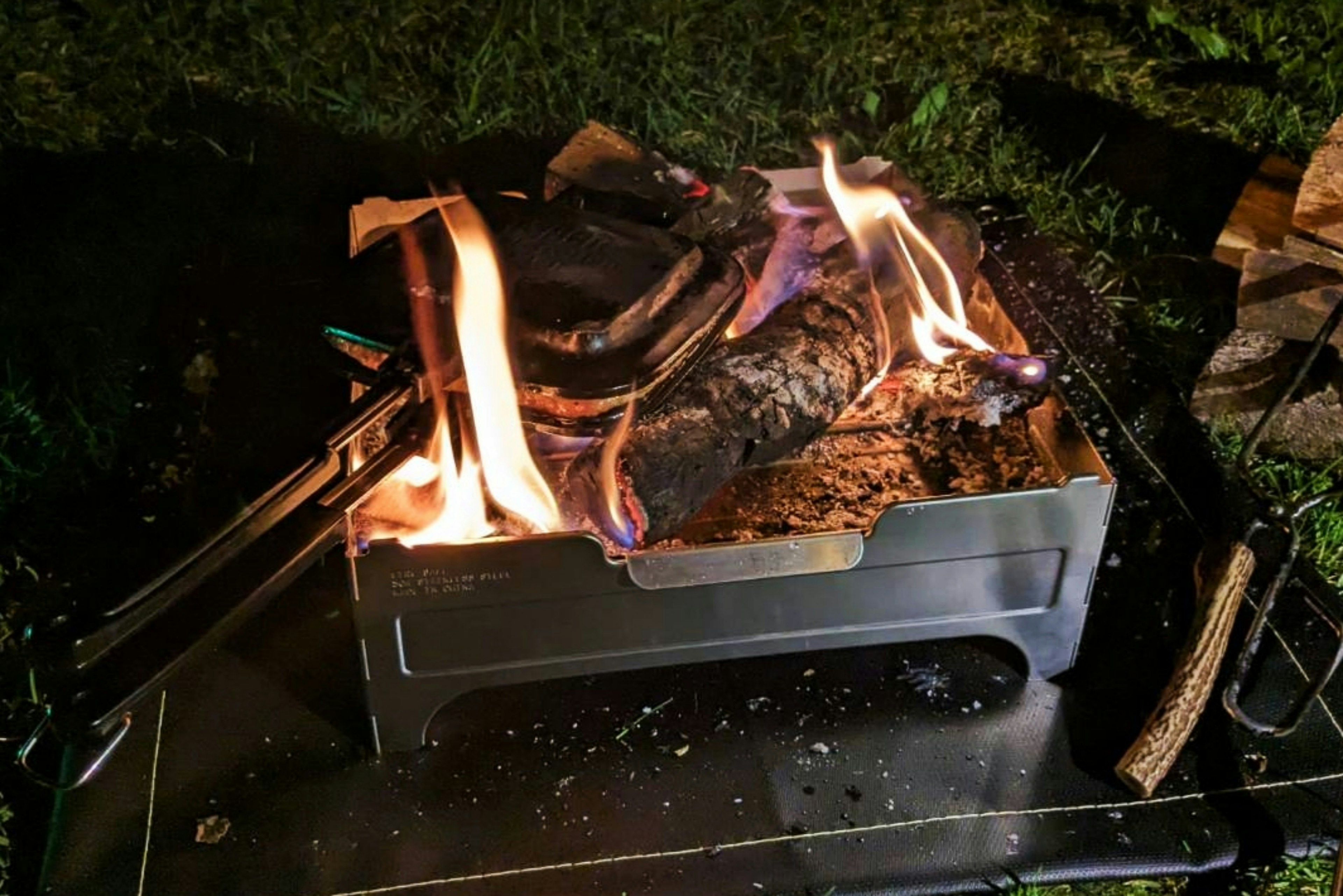 Nighttime campfire with flames and burning wood