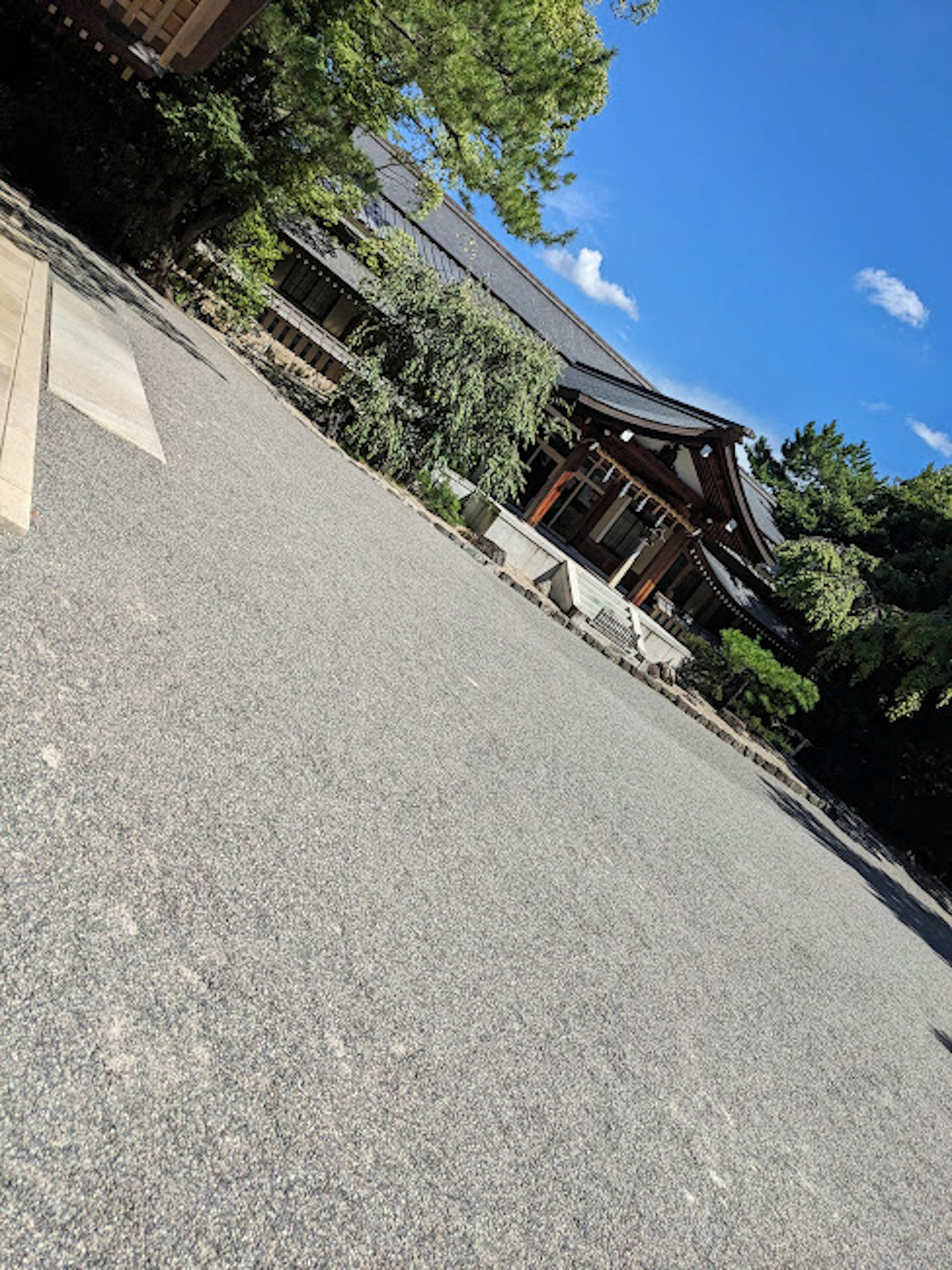 Traditional Japanese building with a gravel garden under a blue sky