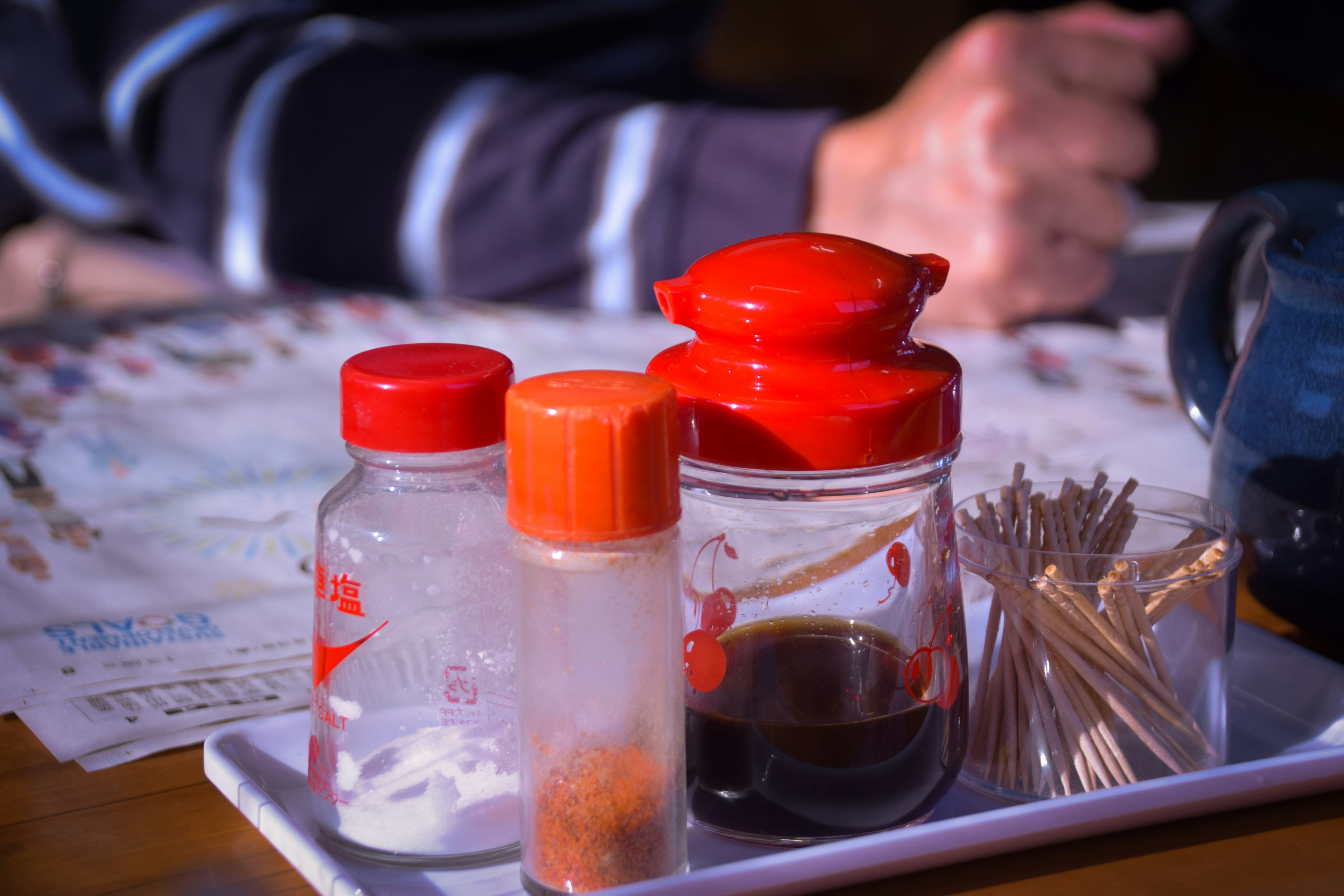 Condiment containers and toothpicks on a table