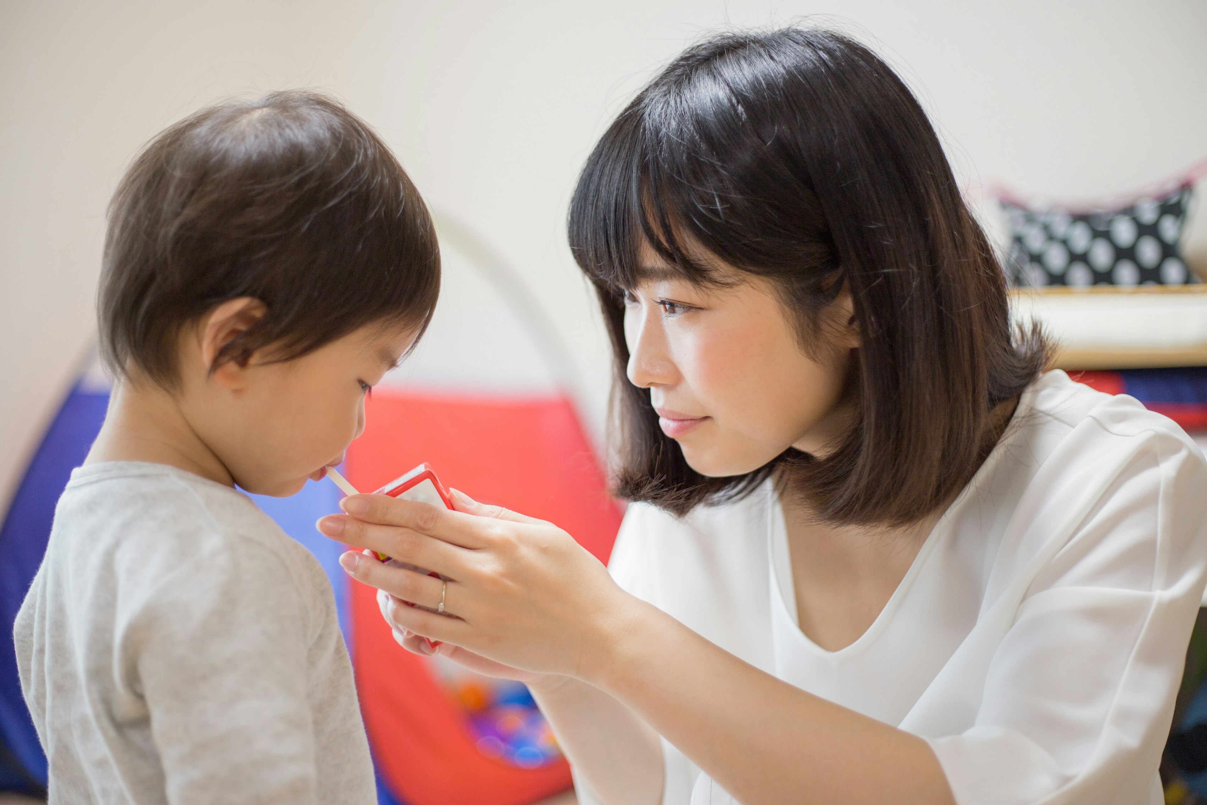 A mother giving a snack to her child