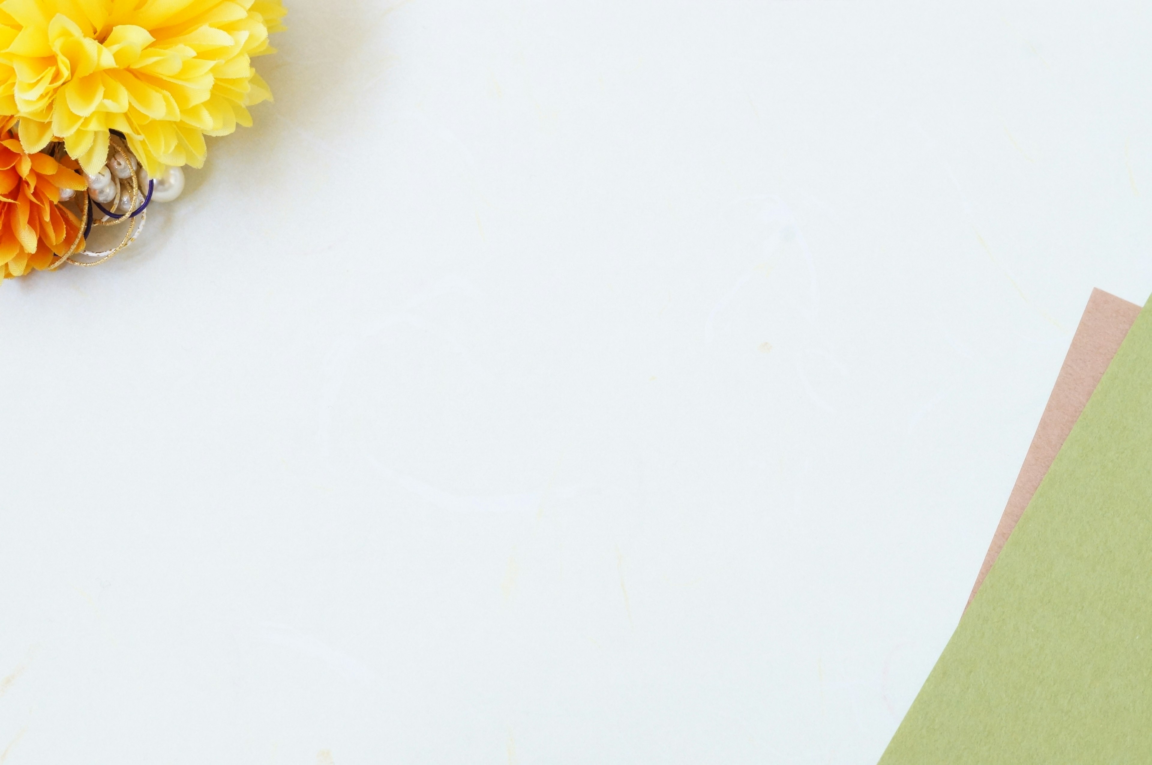 Simple design featuring a yellow flower and colorful papers on a white background