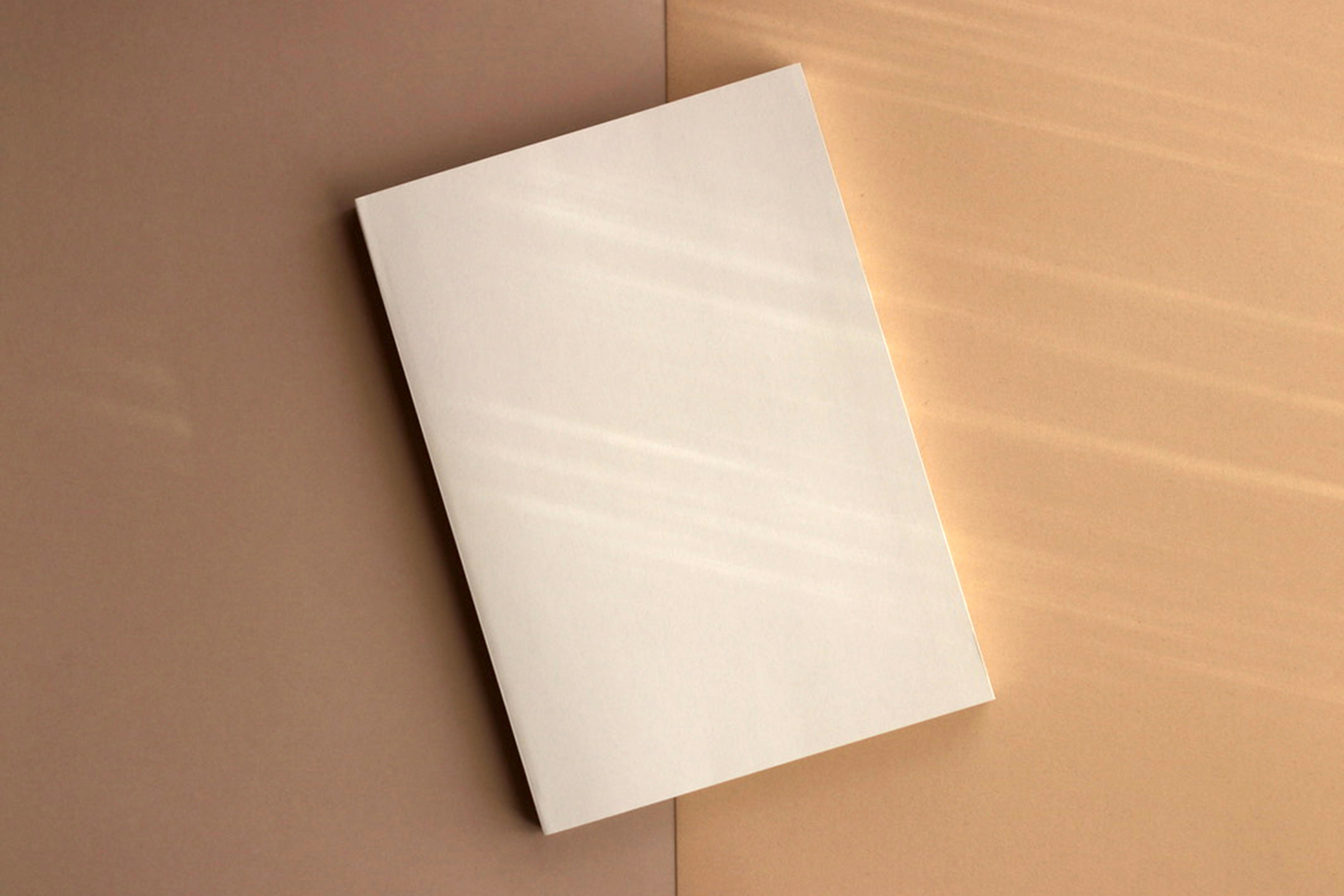 A white notebook placed under soft natural light