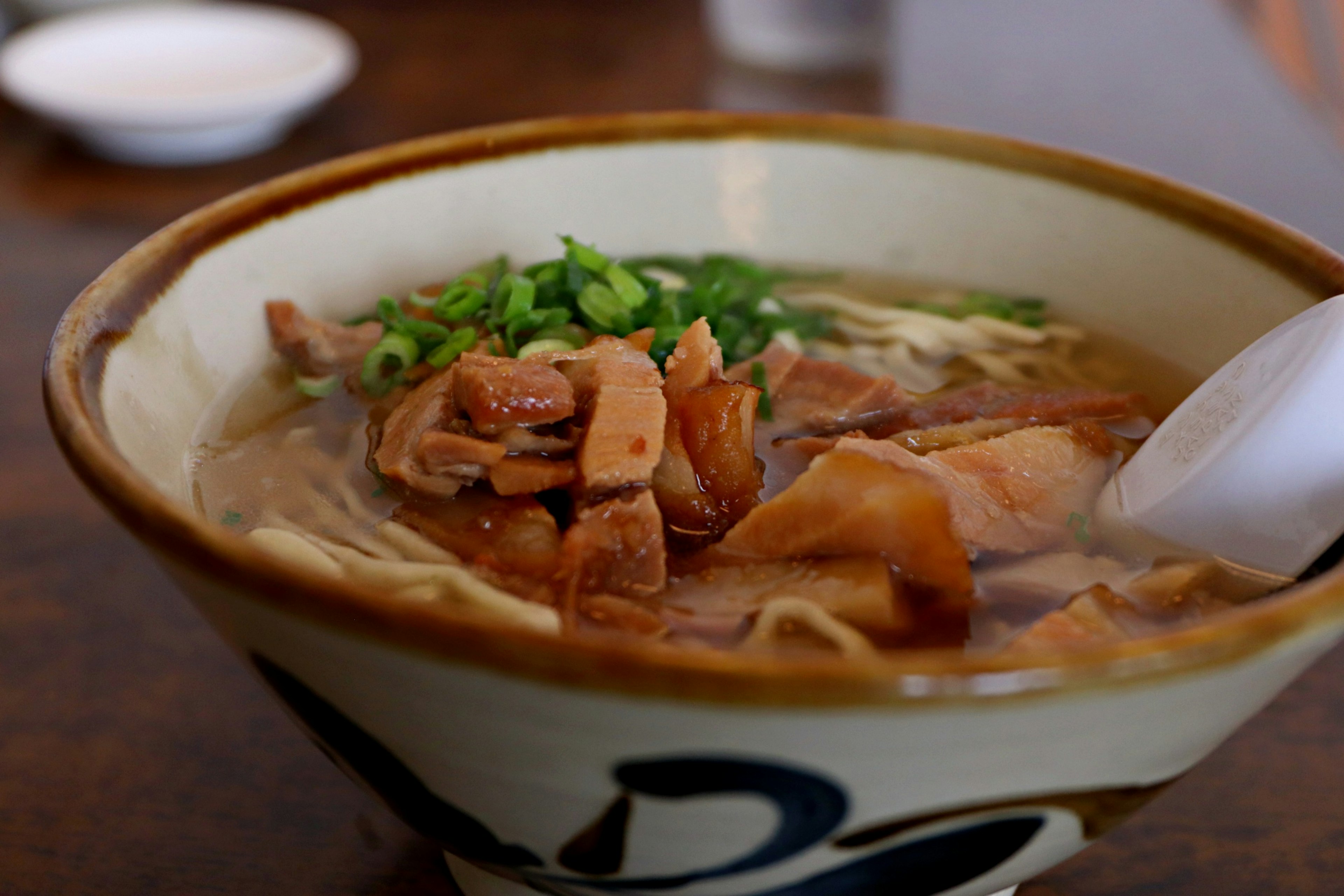 Mangkuk ramen dengan kaldu dan daging iris